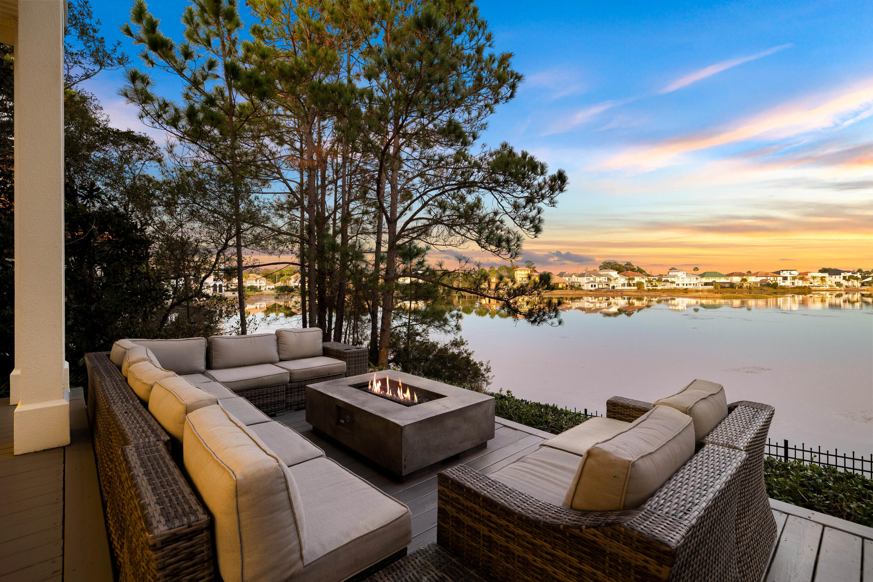 This exceptional three-story lakefront home in the gated community of Destiny West offers breathtaking water views, luxurious finishes and a perfect combination of comfort and sophistication. Designed for those seeking a primary residence, second home or premium vacation rental, this beautifully maintained four-bedroom, four-bathroom retreat provides an elevated coastal living experience just moments from the beaches of Destin. From the moment you step inside, floor-to-ceiling windows showcase sweeping lake views, filling the open-concept living, dining, and kitchen areas with natural light. High-end details, including custom woodwork, chandeliers and rich hardwood flooring, create an inviting yet refined atmosphere. The gourmet kitchen features granite countertops, custom cabinetry and premium appliances, while the spacious living area, complete with a fireplace and motorized window treatments, is ideal for relaxing or entertaining.
The second-floor primary suite offers a private retreat with a separate spacious balcony, a fire pit, a spa-like ensuite bath, and a generous sized walk-in closet with custom built ins. The third floor is a versatile space with a king bed, ensuite bath and kitchenette, making it ideal for guests or a multi-purpose retreat.
The backyard terrace is a showstopper, featuring a fire pit and panoramic lake views, creating the perfect setting for evening gatherings. Inquire within for ideal private pool plans and renderings. With proximity to James Lee Park and pedestrian & golf cart friendly Scenic Highway 98, this home offers the best of the Emerald Coast lifestyle, whether as a full-time residence or an income-generating vacation rental.
The gated Destiny West community further elevates the living experience with its verdant landscaping, a large, seasonally heated swimming pool, hot tub, fitness center, tennis court, and a grand clubhouse. Landscaping is paid quarterly to the association so no need to bring your lawn equipment.
Perfectly positioned and meticulously upgraded, this home is a rare opportunity to own a premier lakefront property in one of Destin's most sought-after communities.