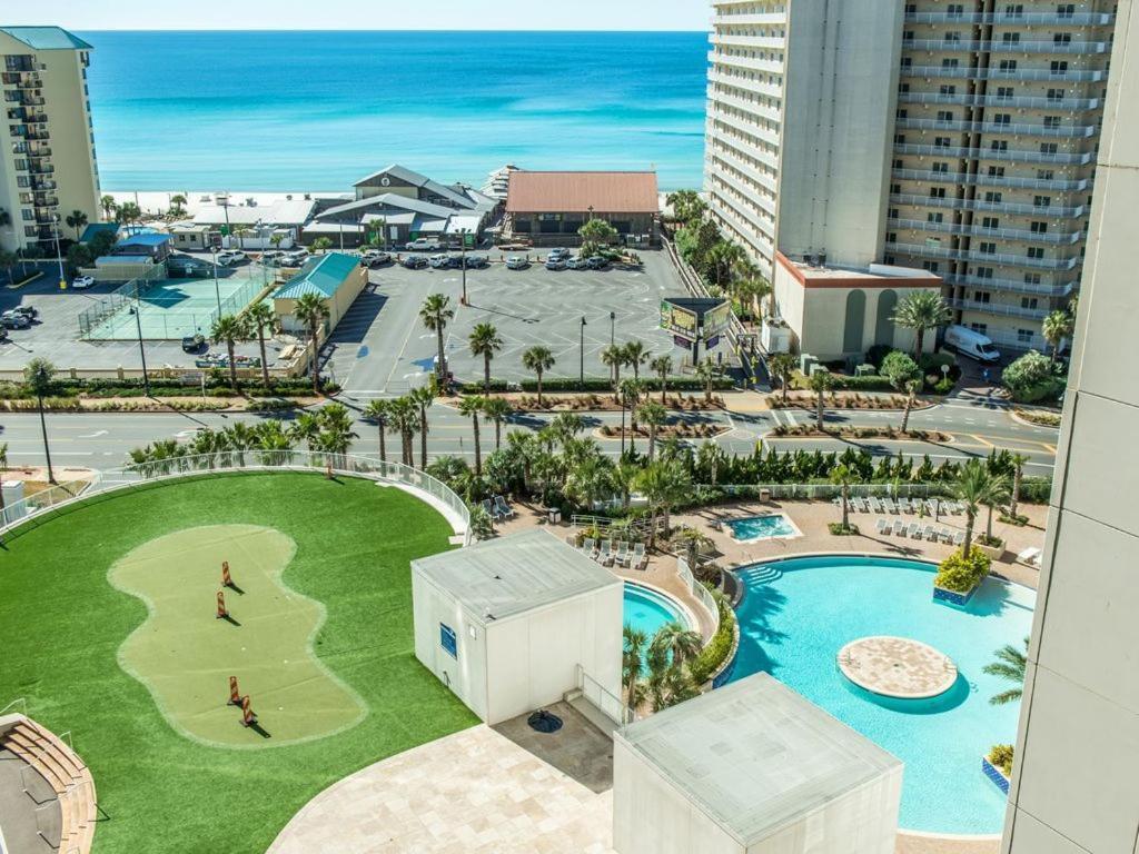 The bright Panama City Beach lights have stopped here! This gorgeous LAKEFRONT 3 bedroom + bunk room unit features stunning lake and gulf views from its oversized, private wraparound balcony. A Corner unit that showcases a breathtaking sunrise view and is the prime location for the nightly water show. Just Steps Away From The World's Most Beautiful White-Sand Beaches, and is the one your friends, family and vacationing guests will enjoy for a lifetime! Gorgeous granite countertops, LVP flooring and all new furniture! Sold Fully furnished and turn key ready - just in time for summer rentals! Boasting a phenomenal historical rental. You'll love Easy Beach access, 5 pools, 2 hot tubs, play area for kids, splash bar, putting green, fitness center w/ gulf view, covered garage parking and more