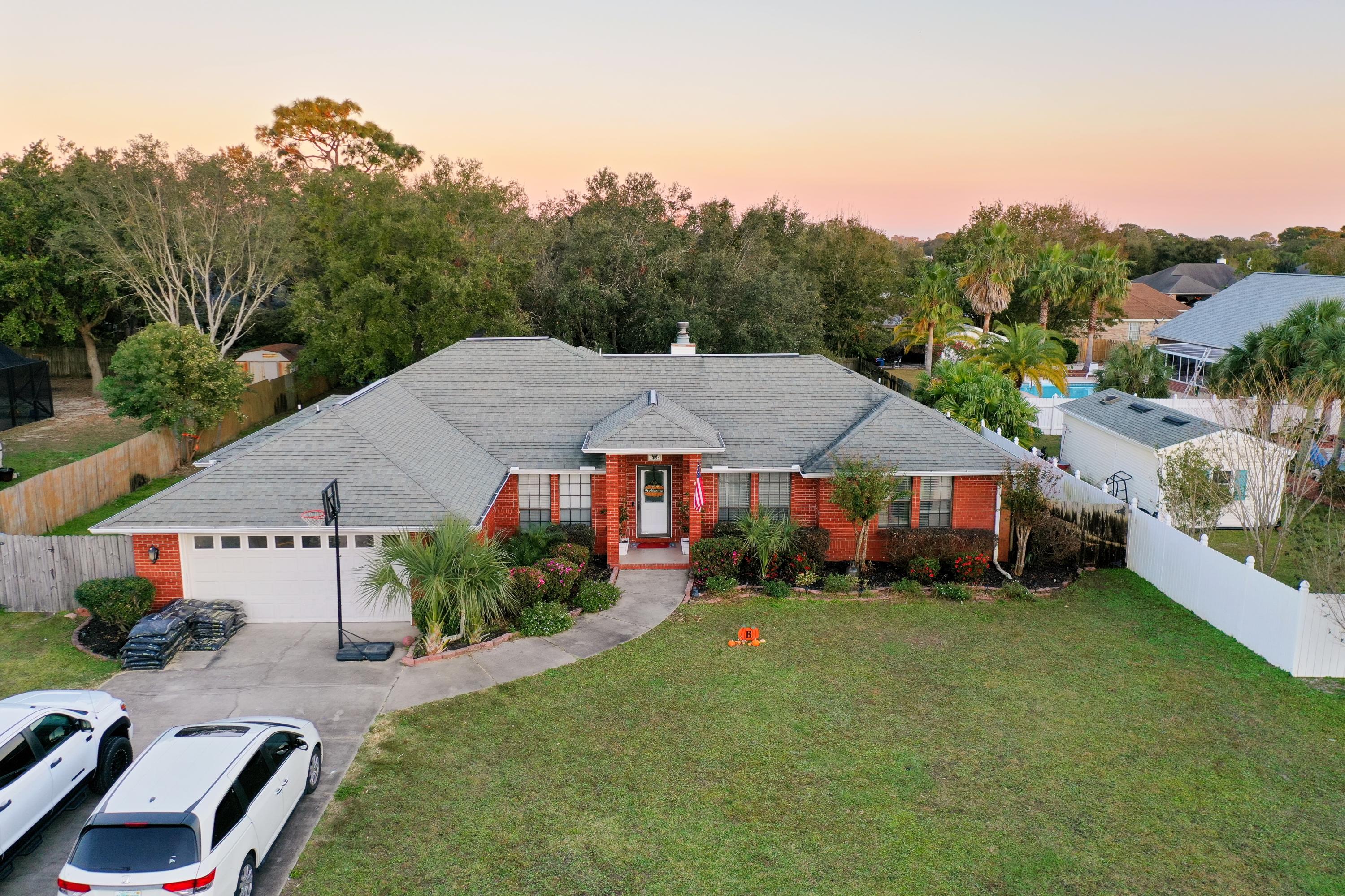 Beautiful home located in the wonderful Sound Retreat subdivision. 5 minutes from A rated schools and a short drive to the beach. This all brick home with oversized garage is situated on a very spacious lot. The split floor plan has much to offer with 4 bedrooms and 2 baths. As you walk through the front door, the ceramic tiled foyer opens into the living room. This room features beautiful hard wood flooring and offers a fabulous fireplace to cozy up to on cool winter evenings. The spacious kitchen features a large bar - perfect for large gatherings. And you can relax in your heated and cooled Florida room.The fenced backyard is perfect for entertaining and relaxing under the pergola with plenty of room to add a pool.