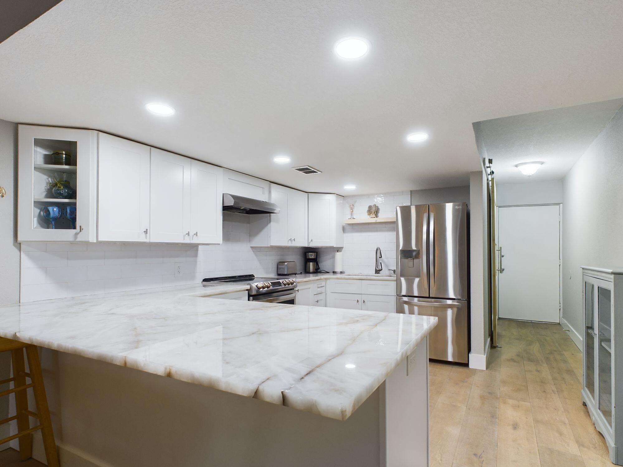 Renovated ground floor condominium nestled in the heart of Destin, boasting stunning views of the emerald waters at high and Crab Island. This inviting space features an open-concept living area, a fully updated gourmet kitchen, modernized bathrooms, and elegant wood-look LVP flooring throughout. Residents can indulge in various amenities such as a pool, tennis courts, a community room, and a dock. Situated within a gated community overlooking the Bay, residents can witness the captivating transition of clear emerald waters during high tide, alongside tranquil moments on the balcony observing boating activities and playful dolphins. This sanctuary prohibits short-term rentals, offering a 12-month lease option for a serene living experience. The Valencia Gated Community offers a plethora o