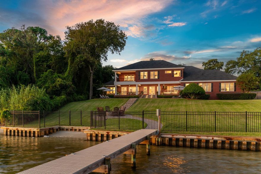 Nestled among a canopy of majestic live oak trees on a sprawling 3/4-acre lot, this custom-built ICF home boasts 144 feet of water frontage on the Santa Rosa Sound & intracoastal waterway. From this prime waterfront location in the Fort Walton Beach area, you'll enjoy stunning sunrises, sunsets, and even glimpses of the Gulf.Perched atop a bluff in a flood zone X, this energy-efficient ICF home is built to be resilient against mother nature and stand the test of time.  This meticulously crafted home maximizes every inch of space, offering an inviting blend of spaciousness for entertaining and cozy comfort, all while showcasing stunning views of the Santa Rosa Sound from every room. This sprawling 7 bedroom, 7.5-bathroom estate spans 7,359 square feet across three separate wings. Each bedroom has their own en suite full bathroom. There are two master suites, one upstairs and one downstairs. Each level is thoughtfully equipped with its own laundry facilities, ensuring convenience and ease in everyday living. The main floor has a   spacious living room as well as a dedicated office space and cozy fireplace den, providing versatile spaces to accommodate all your needs. 

The gourmet chef's kitchen is sure to be the heart of the home, featuring custom cabinetry, a 6-burner Wolf range, and and integrated Sub-Zero refrigerator, all centered around a large island making it the main attraction for family and friends to gather.  Enjoy of the luxury of multiple dining spaces with two designated indoor dining rooms, and the option of entertaining outside on the oversized back patio overlooking the expansive backyard with saltwater pool and serene panoramic views of the "Sound Island Chains," with white sandy beaches and beautiful estuary landscapes. Guest can arrive by land or sea, pulling right up to the deep water dock, featuring a 40,000-pound boat lift, multiple slips, and thru-flow decking. The slips and water around the dock are deeper than most in the area because the intracoastal channel runs alongside the property.  Depths range from 5.9-9.2 feet. In the front of the home, the split 5 car garage and round about pavered driveway ensure storage and parking are never an issue. One of the garage bays is currently being used for a gym. The neighboring lot with pavered driveway is ideal for overflow parking and available for a separate purchase price in addition to the main house. You can keep it for parking and green space or build another single family residence next door. 

Throughout the home you'll want to take advantage of the whole home stereo systems and surround sound.  This home is the perfect blend of modern luxury and casual coastal elegance and it is truly one of the most coveted waterfront locations in the entire Fort Walton Beach area just a 15 minute boat ride from Crab Island and the Destin Harbor, or 10 minutes from the tranquil islands of Navarre Beach. 

All major systems in the home have been updated in recent years. Roof (2023), New 40,000lb boat lift and jet ski lift (2023), New salt water pool equipment (2023), 2 new HVAC units (2023), New water heaters plus so much more. Please reference the additional documents for more info on renovations and age of items.  This home was built using Insulated concrete form (ICF) which has become an elevated standard for high performance residential construction using insulated foam and reinforced concrete blocks to shape of the exterior walls of the home.  This method ensures a sound proof, energy efficient, and natural disaster resistant home which is structurally superior for years to come.

Don't miss this opportunity to make your waterfront dreams a reality!
