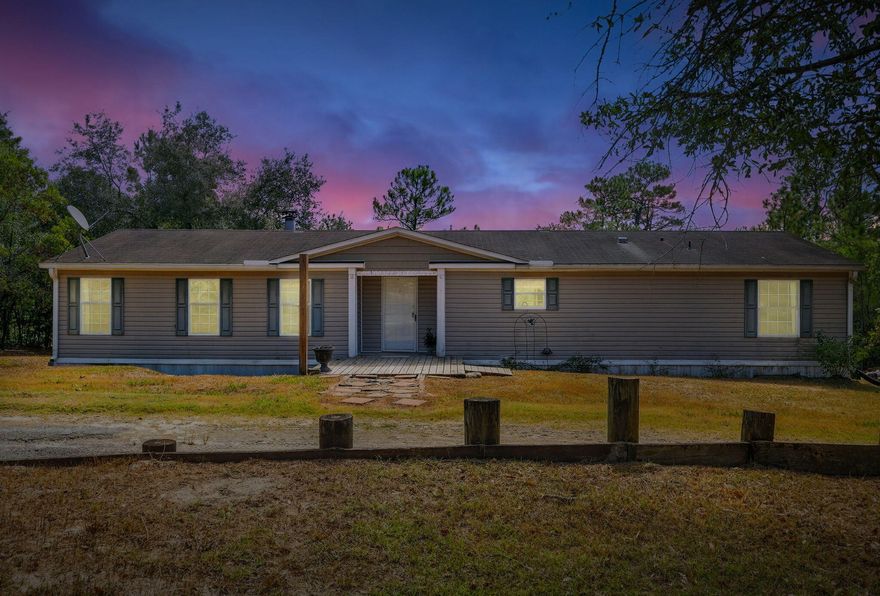 No HOA! Approximately 1,700 square foot manufactured home situated on approximately 0.81 acres of land. The home features three bedrooms and two bathrooms. The open floor plan provides ample living space and leads to a large covered deck that's ideal for entertaining. The kitchen includes a breakfast bar and adjacent dining area. The primary bedroom boasts a spacious walk-in closet, and the bathroom features a garden tub. The property also includes a wood-burning fireplace, providing cozy ambiance on cooler evenings. There is a storage building on the property for extra storage. The home is situated in a private, quiet setting, conveniently located near I-10 and the town of Defuniak Springs. Residents can enjoy the tranquility of country living while being in close proximity to the City.