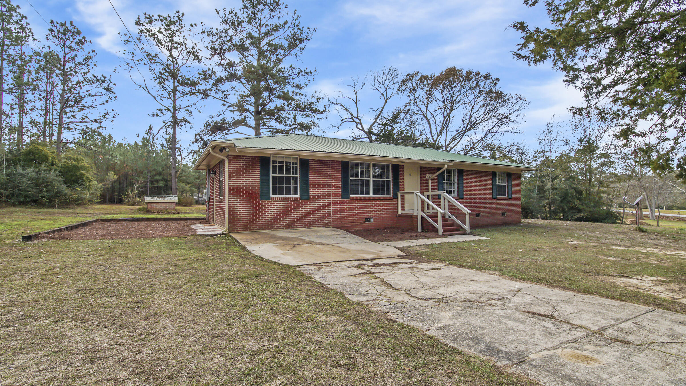 Rare find of a 4 bed/2 bath brick home in a great neighborhood - Ten Lake Estates. Sitting on nearly 2 acres! Open floor plan with laminate and tile flooring throughout. Other updates have been done over the years, including kitchen and bath renovations. The garage was converted into a master bedroom with tile shower and combination laundry space in the master bath. The dining area leads out the french doors to the open back patio and yard. With nearly 2 acres, there is amazing room to create a back yard of your dreams. Membership in HOA is optional - by joining you have access to the lakes for fishing, etc.