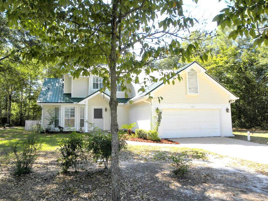 PRICE REDUCED!! FANTASTIC CUSTOM BUILT HOME SITUATED ON OVER A 1/4 ACRE LOT IN THE DESIRABLE FOXWOOD ESTATES A GOLF COUNTRY CLUB COMMUNITY! Spacious living area with high vaulted ceiling, fireplace for those cozy winter nights and beautiful laminate flooring throughout. Dining room opens into the living area making entertaining a breeze. Large kitchen which features an abundance of cabinets and counter space, nice appliances to include a stainless steel refrigerator and tile flooring. Breakfast area has a bay window with plantation shutters. Master bedroom has cathedral ceilings and is conveniently located downstairs. Master bath has a extended vanity with a make-up station, garden tub, separate shower and a walk-in closet. Half bath downstairs. Upstairs has two additional