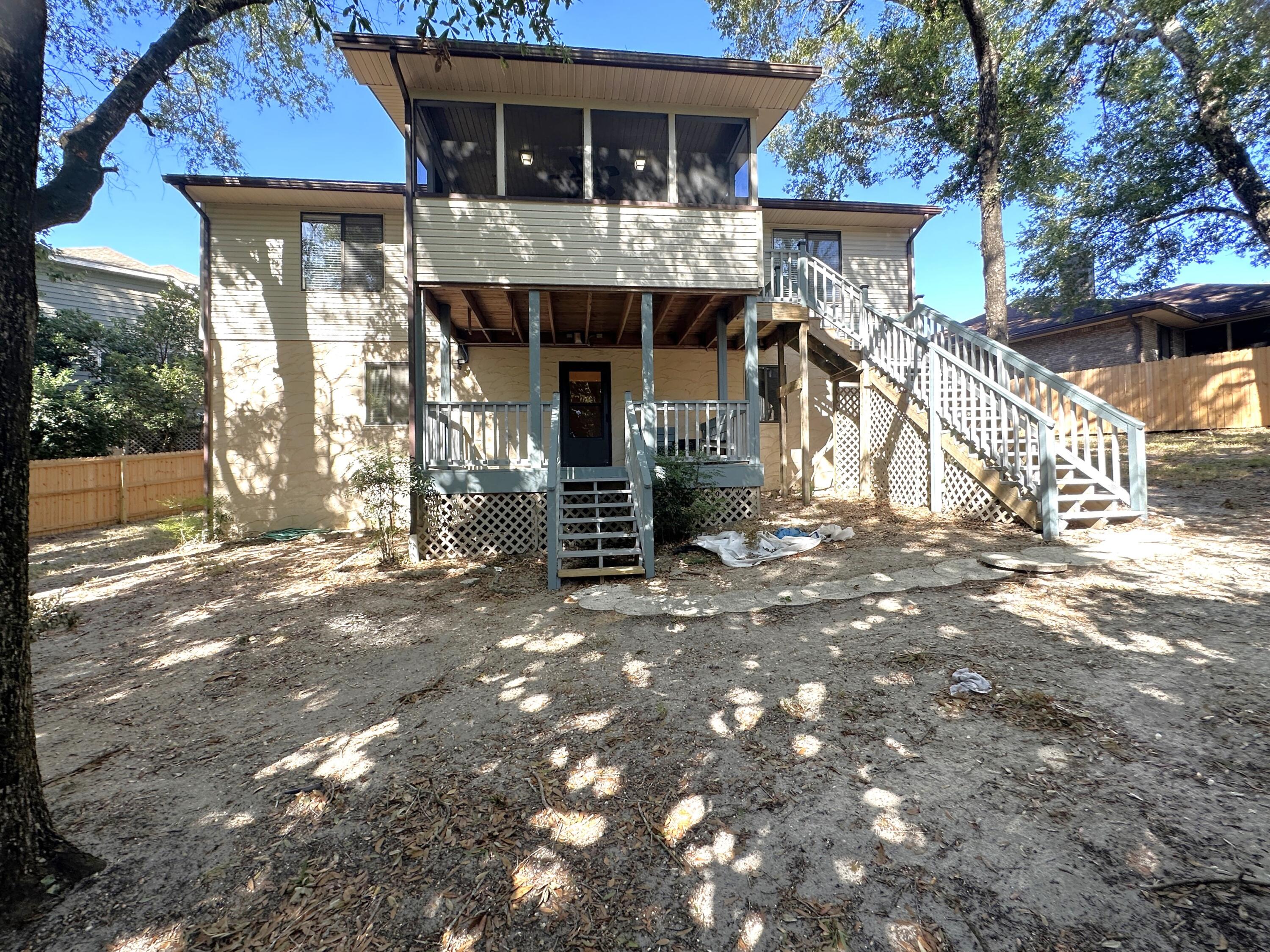 Hidden Gem tucked away in Niceville's Rocky Bayou area Rockywood Phase 3 on a quite cut de sac.  This is a four bed three bath home with a walkout basement offering two separate living spaces with fantastic porches and a great backyard. Newer HVAC, water heater, roof and updated kitchen and bathrooms. Upstairs/front entry has three bedrooms including the master en suite, two full bathrooms, living and dining space, kitchen, screened in porch and a double car garage lined with a shelving. Downstairs is an additional bedroom, a third full bathroom, another living space with a built-in wet bar and a walkout covered porch. The back yard has a back gate that opens to a City of Niceville municipal park area which has remained undeveloped but is often used for walking and exploring.  Assume VA