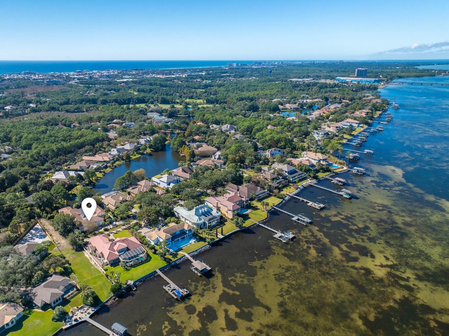 Set on an impressive half-acre homesite inside the private gates of Regatta Bay, 455 Admiral Row is the kind of property that immediately sparks imagination. Spanning more than 5,000 square feet on one thoughtful level, this custom-built residence combines architectural drama, incredible natural light, and a layout with the rare potential to become a truly glamorous coastal showpiece.At the center of the home, an extraordinary 80-foot gallery library steals the spotlight--lined with floor-to-ceiling bookshelves, French shutters, and intricate plaster molding imported from England, including details inspired by 12th-century French cathedrals and abbeys. It's a breathtaking moment of character that sets this property apart from anything else on the market.