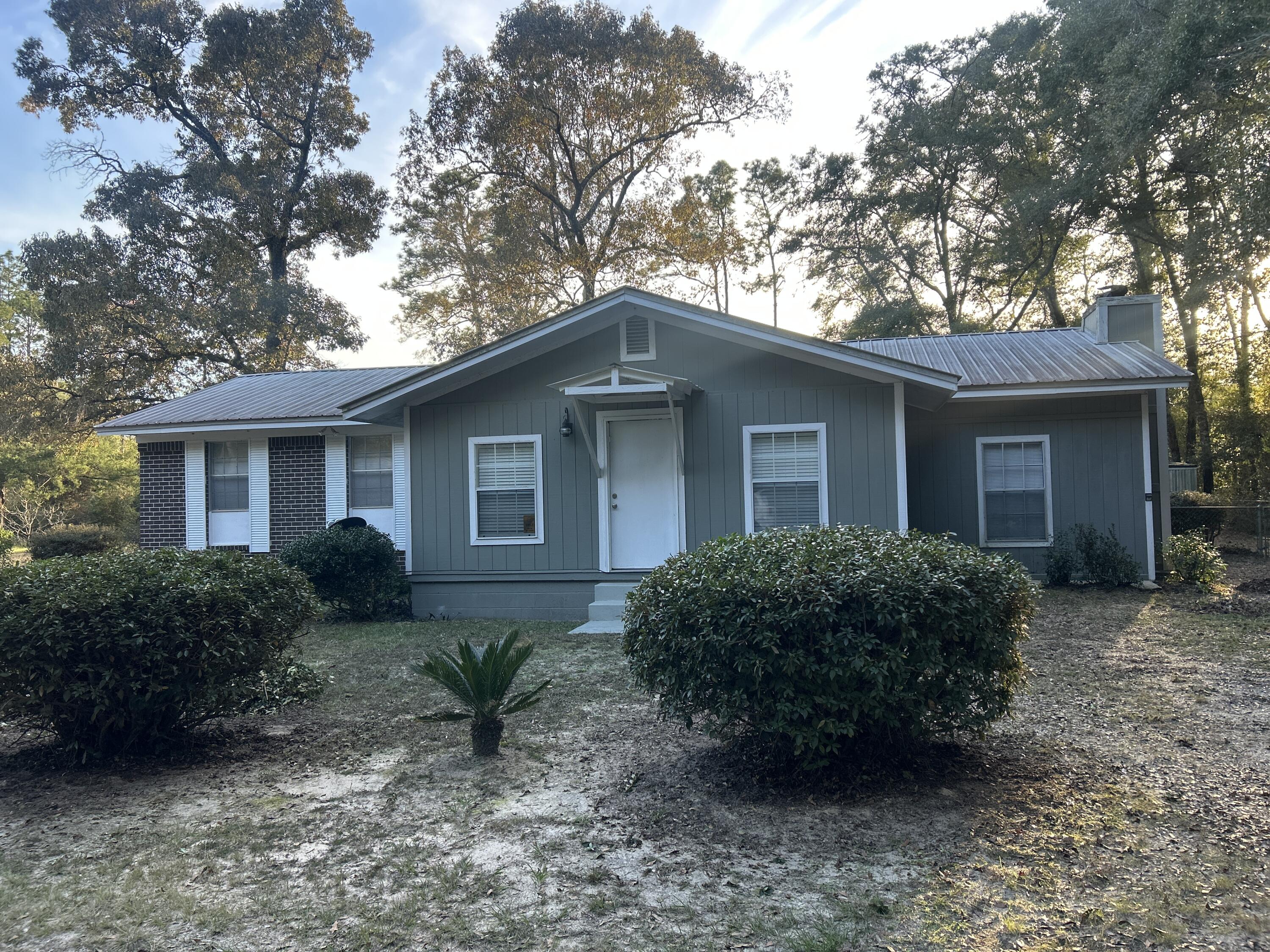 Updated brick home fronting paved road in Ponce de Leon city limits is waiting for you to call home.  Updates include tiled baths, tiled kitchen counters, freshly painted, newer HVAC unit. Carport has been enclosed for a spacious den including a fireplace. Kitchen has Dishwasher, Microwave, and Refrigerator. Front porch has been enclosed for an extra game room or office area.  French doors to deck out back. Entire yard is chain link fenced. One area of fence has damage from tree falling.  Back yard has 16 x 12 utility building. Short drive to Holmes county schools.  Panama City beach is 45 miles. Interstate 10 is 1.5 mile for ease of travel. Call for a showing today!