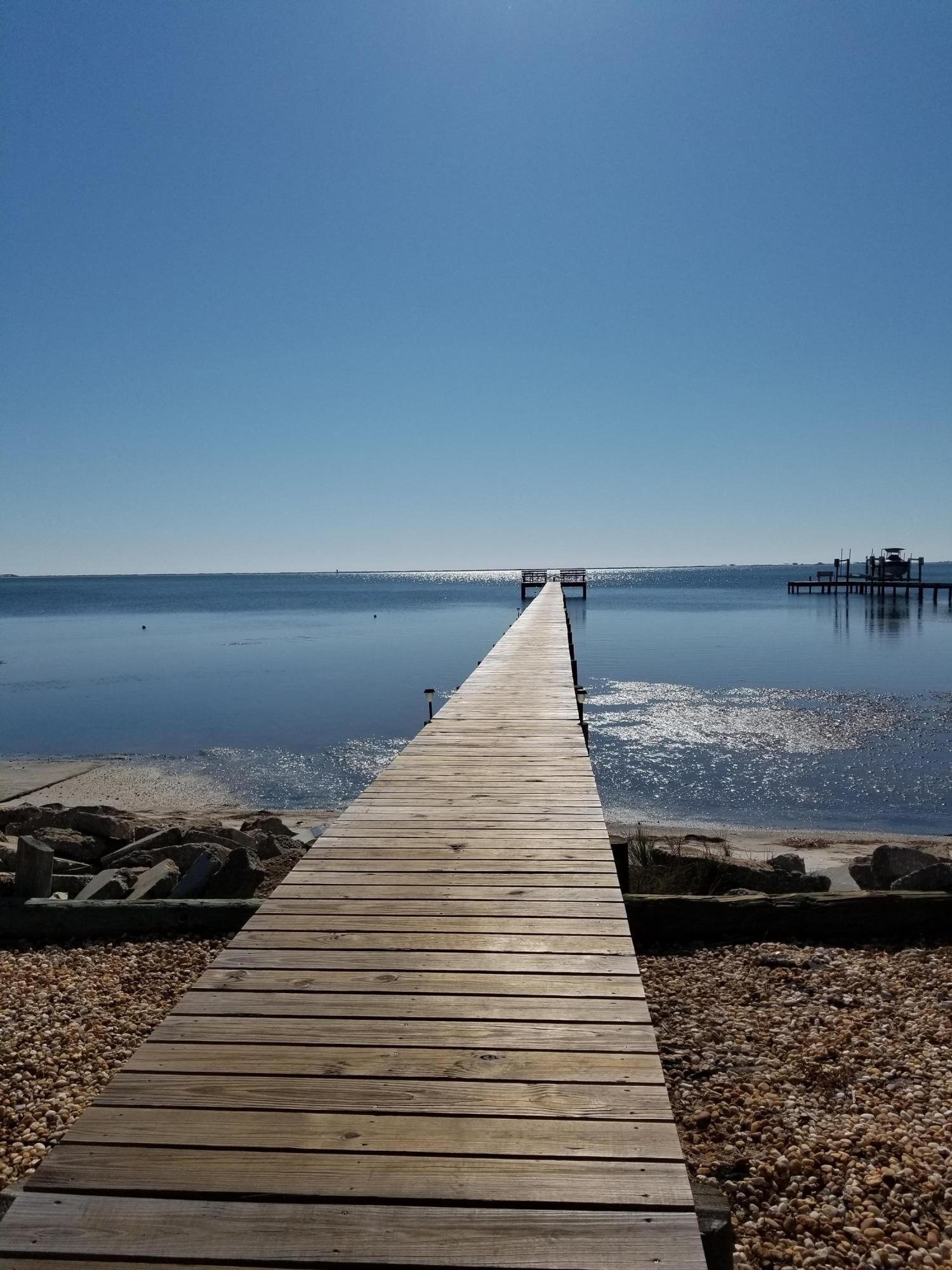 Looking for a perfect location for your new dream home. Check out this vacant lot ready for your new home in a great waterfront community with 94' on the pond in your back yard. This community offers deeded beach access on the sound with a dock for fishing and a community pool and tennis courts. Seller has a survey available.