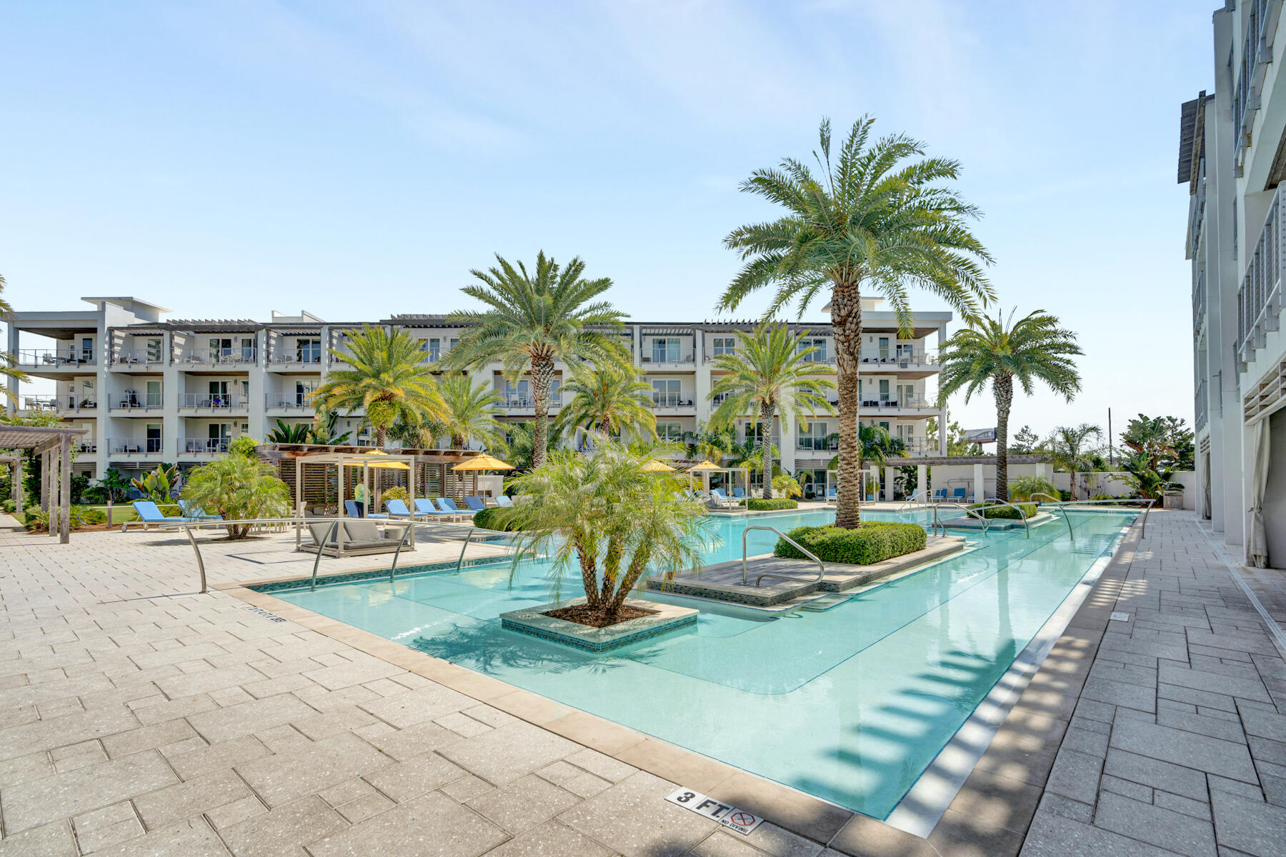This fully furnished 3 bedroom 3 bathroom condo offers gorgeous views of the palm trees and cabanas around the Resort-style pool. Directly next to Rosemary Beach, at the intersection of Hwy 98 and Hwy 30A. The kitchen has an oversized island with a sink and bar seating around the recycled counter tops. Stainless steel appliances with gas cooktop. From the kitchen island, look into the living area with gas fireplace and mounted TV. A dining table seats six. Another private balcony is off of the living room. The master bedroom has a king size bed and opens up to a spacious private balcony. The master bath has double vanities a garden-style soaking tub and separate shower. The second guest bedroom is furnished with 2 queen size beds and a private balcony.