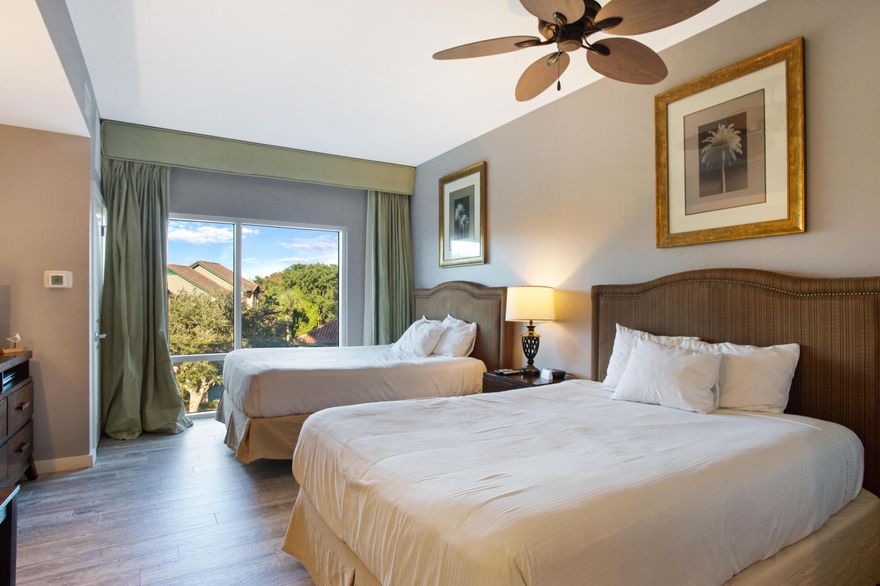 Enjoy your time in this 2nd floor studio looking out to the Resort. Featuring two queen beds, a dining table, and a fully stocked kitchenette, along with easy to clean coastal white wood plank tile throughout the studio. Luau owners and guests enjoy the use of the lagoon-style pool featuring a grotto waterfall, palm trees, loungers, and seasonal tiki bar. Owners and guests also enjoy a private pathway to the beach, fitness center, owners storage cage, and covered garage parking