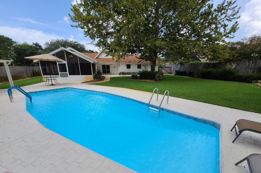 Pride of Ownership home with great curb appeal! Enjoy the beautiful landscape & entertaining back yard with in-ground pool surrounded by beautiful brick pavers, pool house w/electric, screen-in patio, Storage building w/electric & covered patio. CUT YOUR ENERGY BILLS with SOLAR PANELS that is included in sale $32,000. LOW ELECTRIC BILLS.!!! AC replaced in 2016. Kitchen remodeled with granite counter tops & newer cabinets. See Photos. Large living room has Cathedral ceiling & gorgeous fireplace with mantel. Dining area has a built in cabinet bar & mirrors. Spacious master bedroom with 10x5 walk-in closets. Bathrooms remodel with Corian counter tops & newer cabinets. Beautiful wood floors.  Extra concrete driveway for your boat or RV. Close to HURLBURT FIELD Base. Click here for more info.