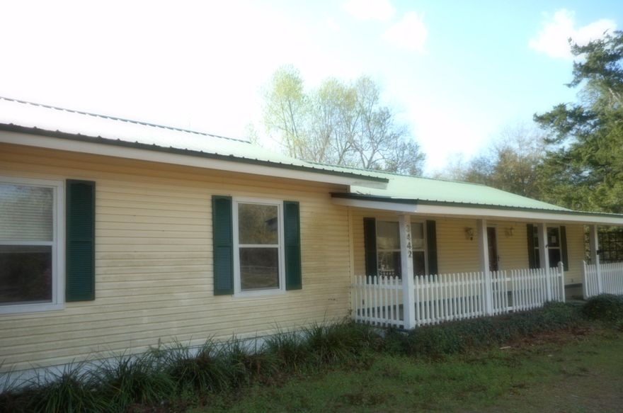 This REO is a vinyl siding home with metal roof, fronting paved highway, convenient to Defuniak. Attached two car carport, screened back porch, covered front porch, sits on 1.3 acre. Flooring is laminate and carpet. Large workshop with work benches. Central heat and air. Great price! Call today.
