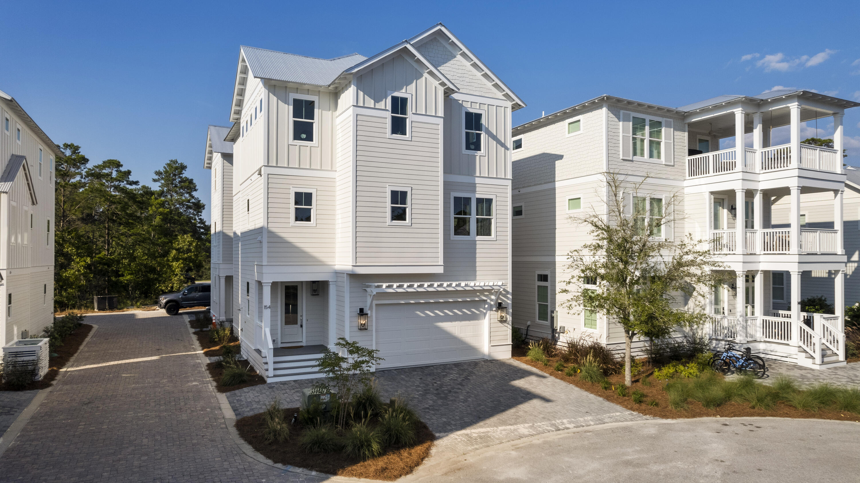Furnished in absolutely beautiful coastal tradition! The Hibiscus plan has the coastal luxury you've been looking for. This three story gem has all the amenities a beach goer desires. The great room features a fire place with custom mantle and stylish finishes with built in window seats on either side. The well appointed kitchen has a stainless vent hood, Thermador appliances that would make a cook excited to entertain, brilliant white cabinets and a kitchen island. There is shiplap going up the stairway at a wainscot level and accent walls in every bedroom. The professional tile selections make the kitchen and bathrooms all exciting spaces. Photo renderings represent how home might look only. Builder reserves the right to make changes due to availability. a vaulted beamed ceiling and focal point accent wall. Off the master bedroom is a common area with charging station providing a place to hang out and relax. in addition to the master bedroom and common area the master bathroom is an relaxing space with a free standing stone soaker tub, double raised sink vanity with rain tree shower head and seamless shower door.