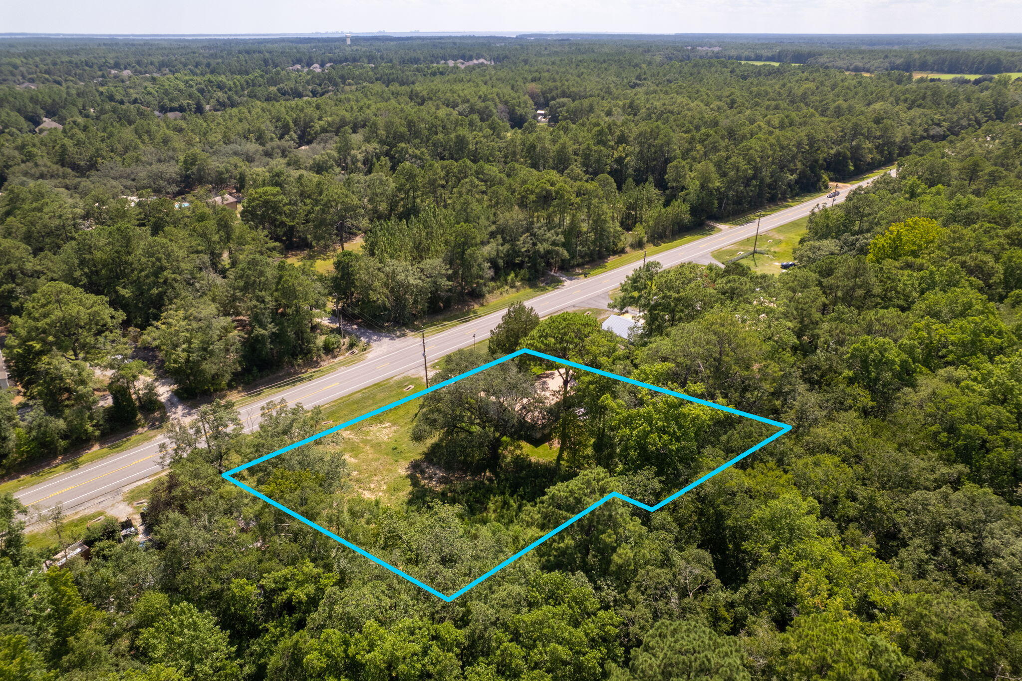 This .5 acre lot and the adjacent .54 acre lot to the east are being sold as one combined parcel. The two parcels combined provide for over 234' of frontage on the heavily trafficked Hwy 20