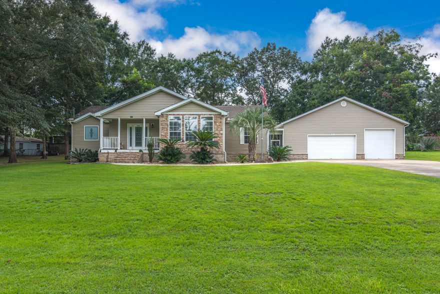 This manufactured home is one of a kind.  It looks and feels like a stick built home.  Home has 3 bedroom 2 baths, 2055 sf, two living areas, an oversized garage for the handyman-or car buff-(32x40) has 8' door for 2-car and 10' foot door, tool room/office, rear screened in porch, and the landscaping is immaculate.  This home was built with 2x6 walls that are sheet rocked, rounded corners, crown molding throughout home, and the owner just added additional insulation in the roof.  The open concept between family room and kitchen is divided by a sit-down bar but has the dining area for those family meals. A spacious master bedroom and bath with double vanity, soaker tub and a separate shower.  The rear screened porch has ample room for all those family functions overlooking shady backyard.