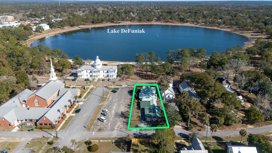 Situated directly on iconic Circle Drive, this historic residence provides picturesque views of Lake DeFuniak and the distinguished Chautauqua Hall of Brotherhood. Just a quick stroll to downtown and situated perfectly between St. Agatha's Episcopal Church and a small parking lot, so there will never be neighbors on either side. Both the spacious dining and living rooms have sweeping views of the lake. The adjacent updated kitchen and breakfast area are conveniently located at the rear entrance with access to the utility/mud room. The master suite is at the rear, along with a second bedroom and a spacious den/third bedroom with direct access to the back porch. The front porch has all the views - and the back porch has all the shade and privacy, and is fully covered for parking and access to the heated and cooled workshop with plumbing, electrical and parking. This is a craftsman's dream work space - or take it a step further and make it living quarters. Whether it's hurricanes or now, snow days, you're covered with a whole house generator! We imagine that many will want to do cosmetic updates, yet the home is very livable and could be updated all at once or over period of time. Come see what everyone is talking about...downtown DeFuniak Springs, just 30 minutes to the bright white beach sand!