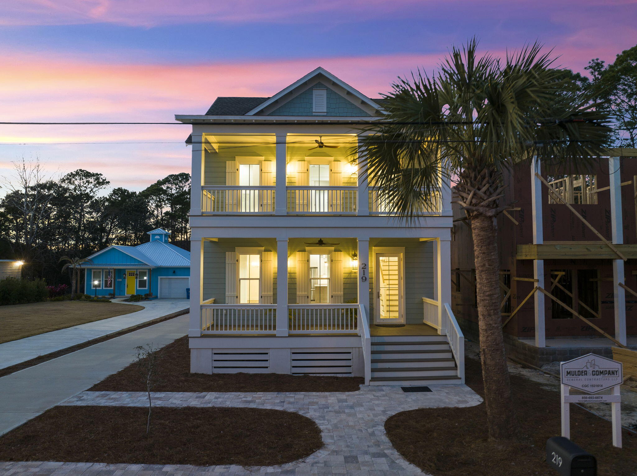 Experience coastal living expertly curated for a life of everyday indulgence. This new construction, timeless gulf-side estate offers a four-bedroom primary home, one-bedroom carriage home atop the two-car garage. As you enter the front door to the foyer, you will find Board and Batten walls and a stunning White Oak Stairway with V-groove (shiplap) walls illuminated by beautiful Chandelier and Wall Sconces. The adjoining family room also features Board and Batten walls as well as exposed ceiling beams. The expansive 13x13 dining room, adorned with an elegant hanging fixture, would generously accommodate a grand table and chairs, creating a lavish space for entertaining.
