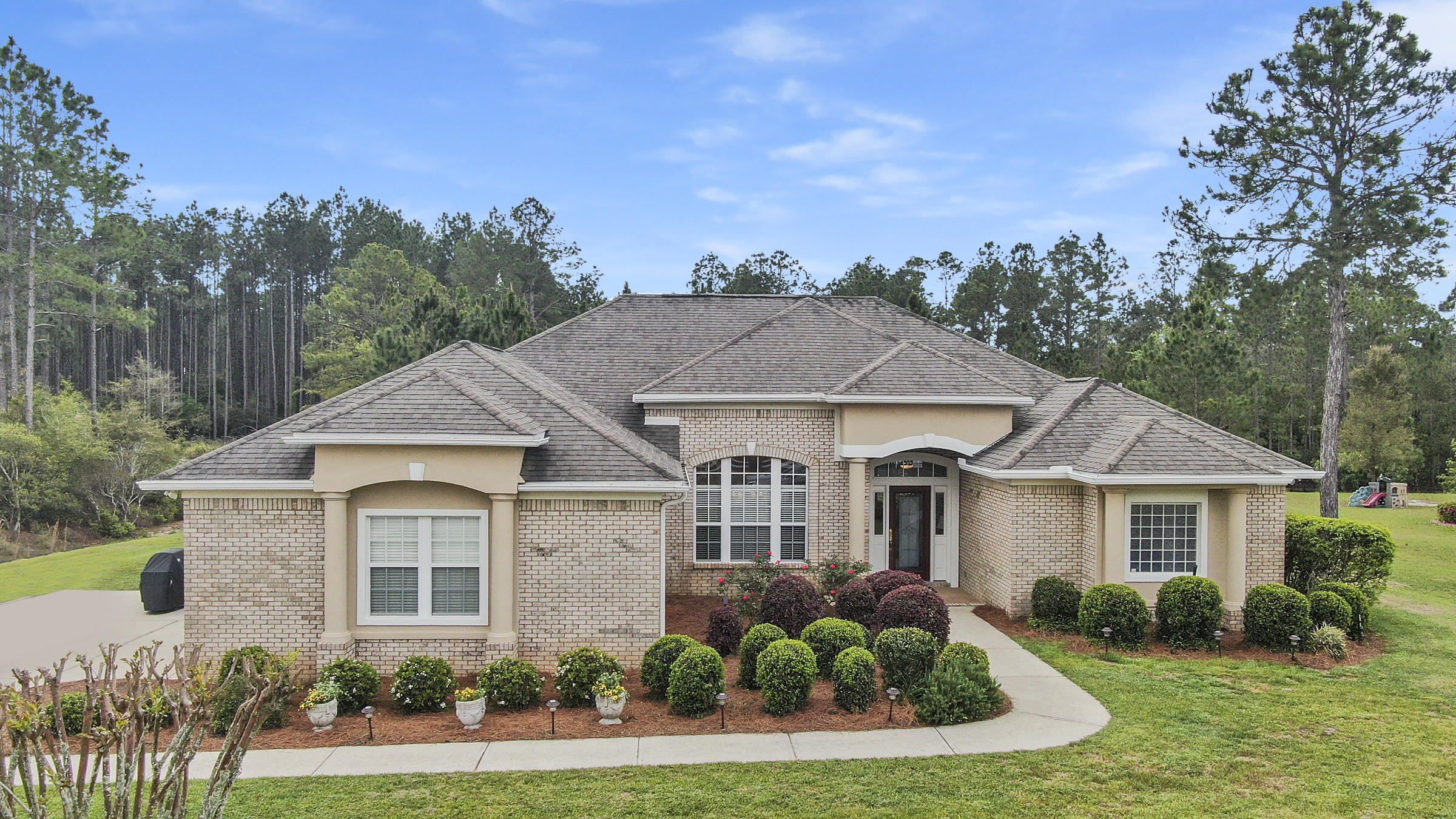 This phenomenal, well maintained, executive style home in Windswept Estates offers an abundance of space and serenity. Situated on .65 acre, enjoy the privacy from your 260 sq ft screened-in back porch. This 4 bedroom, 3 bath home boasts two separate living areas, a formal dining room, a large open kitchen with new Kenmore Elite appliances, a split floorplan, a Jack-n-Jill bathroom, plus an additional third full bathroom, and a fenced-in back yard with plenty of space for a swimming pool. With over 2,500 sq ft, this home has recently been repainted, offers all new appliances including a washer/dryer, new irrigation pump and tank, new garage door rollers and openers, has had regular HVAC maintenance, and transferrable home warranty coverage.