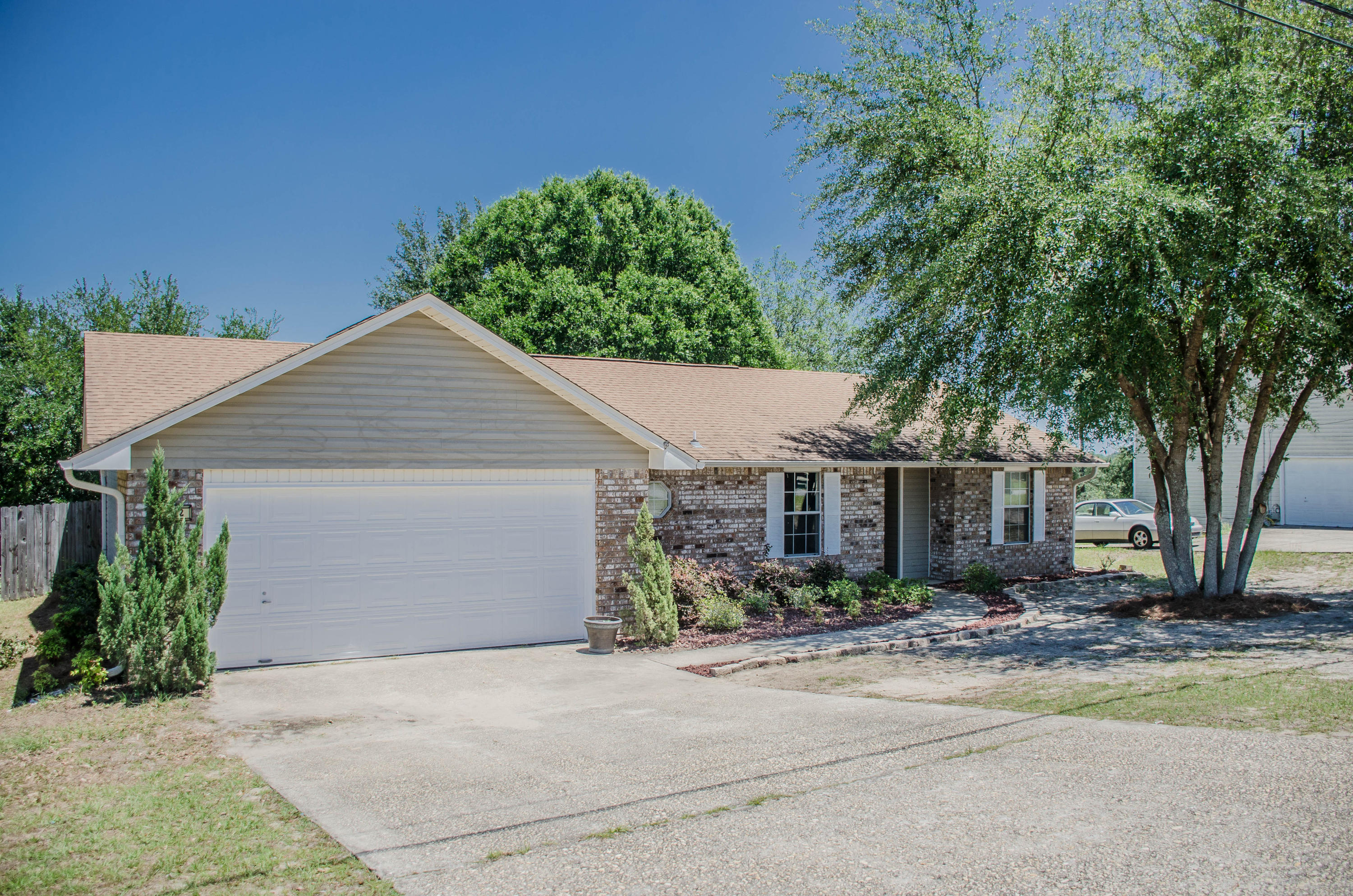 A great home, great location at a great price! This 3 bedroom, 2 bath home is South of I-10, comes with an 1 year American Home Shield Home Warranty ($400 value), and is ready for a new owner. Upon entering the home you are greeted by a vaulted ceiling living room that opens up to both the dining area with wood laminate flooring(also can be used as a play area or office) and eat in kitchen. The kitchen shows off a new over the sink light fixture, black and stainless steel appliances, and large pantry. The popular split bedroom floor plan gives the master bedroom privacy from the rest of the home. The master suite offers a peaceful retreat with views of the privacy fenced back yard and a large master bath complete with double vanity oversized tub/shower combo and 2 walk-in closets.