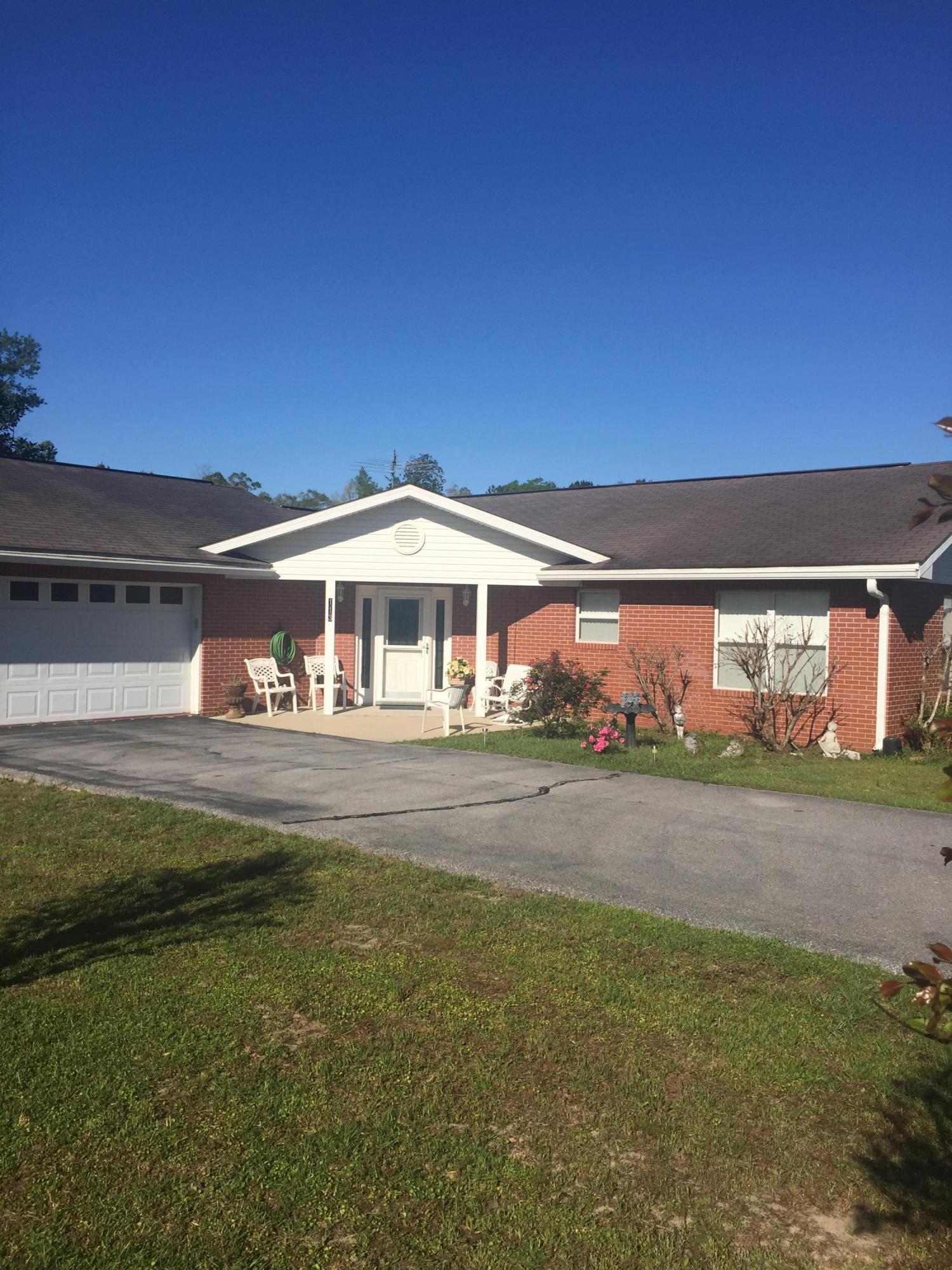 Beautiful brick home situated on 3 acres overlooking a large pond. The brick home has 2 large bedrooms and 2.5 large bathrooms. The living room and dining area are very open and could be put back to a third bedroom if needed. This home has tile flooring and lots of large windows allowing plenty of natural light into the home. There is a small screened back porch overlooking a beautiful private pond. There is also a large garage with an additional kitchen for parties and gatherings. The home also has a large workshop and storage building. The yard is maintained to the pond and has a small area fenced for the animals. The private road is paved to the home. The home has generator that automatically cuts on if electric goes out. Great place!!!!!!