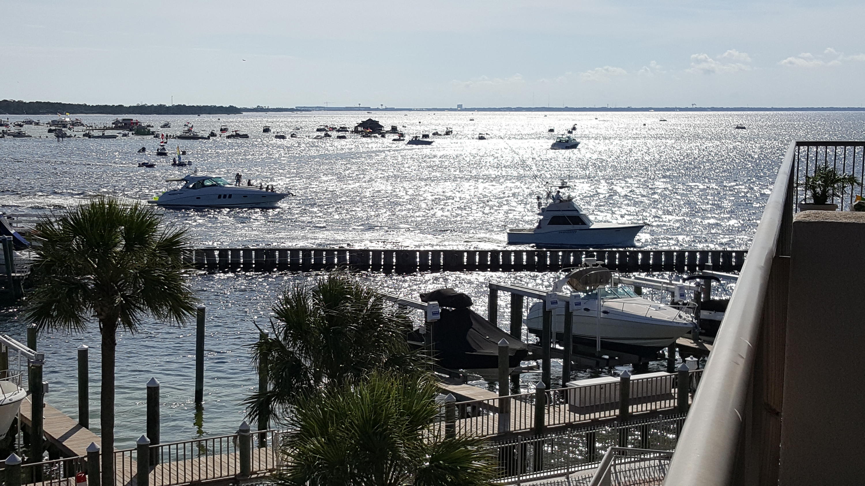 Watch the dolphins play and take in the beauty of the harbor & inlet from this beautiful condo! Secure gated condo, 3 bedrooms, 3 full bathrooms, 2038 square feet overlooking Destin Pass and Crab Island. Enjoy watching dolphins, occasional manatees, fireworks, and daily spectacular sunsets from your balcony. Built in 2004 and completely renovated in 2012 with new paint, carpet, refrigerator, cooktop, washer, dryer, Hunter remote ceiling fans and light, Invisiguard solar window film. 50 pound icemaker, beverage/ wine cooler, & Bali custom solar shades added in 2014. Reserved covered parking directly below the unit, with dedicated lockable storage on same floor. Common areas include BBQ grills, waterfront gazeebo and pool, community room available for large gatherings includes exercise
