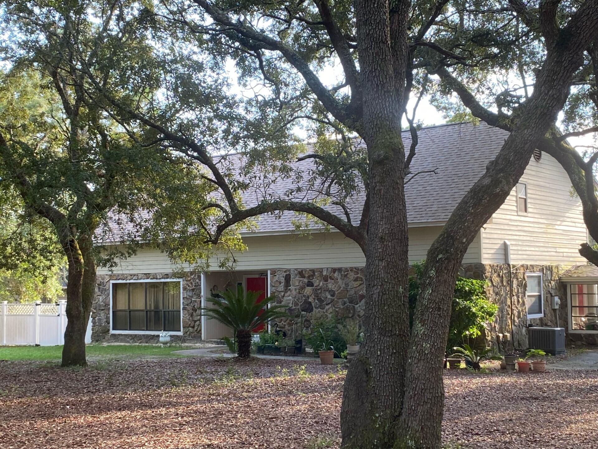 If you need a large home on an acre lot, then come see this 4 bedroom, 3 bath home with a pool in its own building, tennis court, and one bedroom garage apartment with full bath and laundry, for visitors / in-law quarters! Make your appointment, as of Friday, 8 August, as you'll enjoy this expansive home on an acre, with lots of extra storage! Have fun in the full sized pool in its own building, but attached to the home, with sun streaming in from the South, or enjoy playing on the tennis court! No HOA as you are in the county, so you can have chickens, as sellers did, for years! Home has many upgrades: New roof on house & garage '22, new roof on pool room, HVAC on main house, new motor for air handler, new tile downstairs and new LVP flooring upstairs! The hardwood... (please click MORE) cabinets were kept, but painted a light color to balance the dark wood trim. The 18" tile is at a diagonal to enhance the beauty. Besides the tile, the sellers upgraded the kitchen with quartz counters and a new breakfast bar! All 3 baths in the home were remodeled with new tubs and a shower, with the same quartz for the vanities! You have a patio to BBQ or sit in the sun and room enough to have a playhouse, with 4 long poles to build it on. A new header and spring was installed in the garage and you'll love how quiet the garage door opener (changed in '24 for a Genie) is. Be sure to see the complete list of upgrades in the attachment! If your business needs room for storage, you have room to add such on this huge lot! Home has termite bond with Rusty's Pest Control and quarterly bug spray thru June '26. You are one minute from the Mid-Bay Bridge entrance to Destin and the white sandy beaches of the Emerald Coast! White Pont Rd is closed in the summer (Noon - 6 pm on Saturdays) for those trying to get to Destin, so local residents can come and go more easily! Don't forget to call for your appointment! Seller is a licensed Realtor in Florida. Cheers!