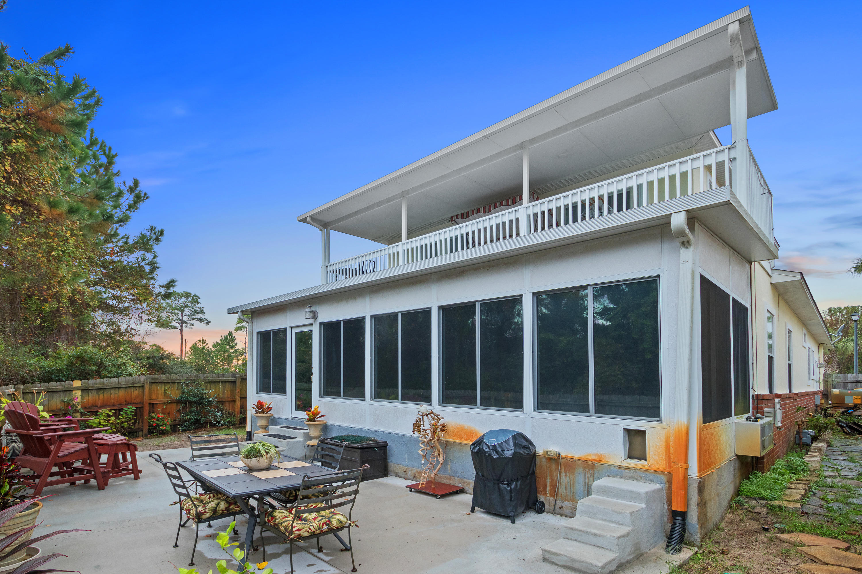 This is your opportunity to own a beautiful home near the beach, shopping venues and the local military installations. This home has gorgeous columns off the welcoming foyer, soaring ceilings, crown molding, a built-in bookcase, transom windows, seperate dining room with tile flooring and expansive chef's kitchen that will delight all types of cooks! The kitchen boasts granite counters, down draft vent for the range, working island for prep space and a breakfast bar! There is under and upper cabinet lighting perfect for the midnight snack found in the huge pantry! The living room is freshly painted with a gas fireplace, and overlooks the kitchen. On the opposite side of the kitchen you will find the extra large, well lit master bedroom with spacious master en suite bath. This bedroom has ample space that provides room for all sizes of furniture. The master bath features a separate tub and walk-in shower, two closets and two vanities, perfect for getting ready in the morning. Through the french doors off the master bedroom, also accessible from the main living room, you will find a large secondary living space currently being used as a craft room. It is spacious enough to hold a couch and TV, or it can be used as a playroom, workout space, or movie room.
Exiting off the secondary living space is the large patio backing up to green space offering a quiet and serene setting for entertaining. There is only one house to your left and no neighbor to your right. At the end of Tecumseh is a dead end offering roughly 10 more homes past this home which allows for low traffic and is easily walk-able.
Upstairs you will find two large bedrooms and full bathroom. Through the larger of the two bedrooms out of the french doors is a spacious covered patio perfect for viewing the Bay and listening to the birds. This second story patio would be a perfect setting for a morning coffee or evening cocktail.