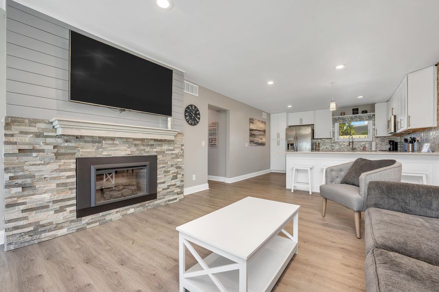 Step into this stunning ground floor unit that has been meticulously renovated, boasting a host of impressive features. The farmhouse sink, granite surround electric fireplace, and elegant LVP flooring set the tone for modern luxury. Say goodbye to carpet as this unit offers a clean and contemporary aesthetic throughout. Enjoy peaceful afternoons on your screened porch, overlooking a meticulously maintained lawn area cared for by the Condo Association. This condo has been thoughtfully upgraded with brand new hurricane-proof windows and sliding glass doors, ensuring your peace of mind. Smart home features like a digital thermostat, Ring doorbell, and keyless door entry add an extra layer of convenience and security to your daily life. Nestled in a wonderful neighborhood with gated security