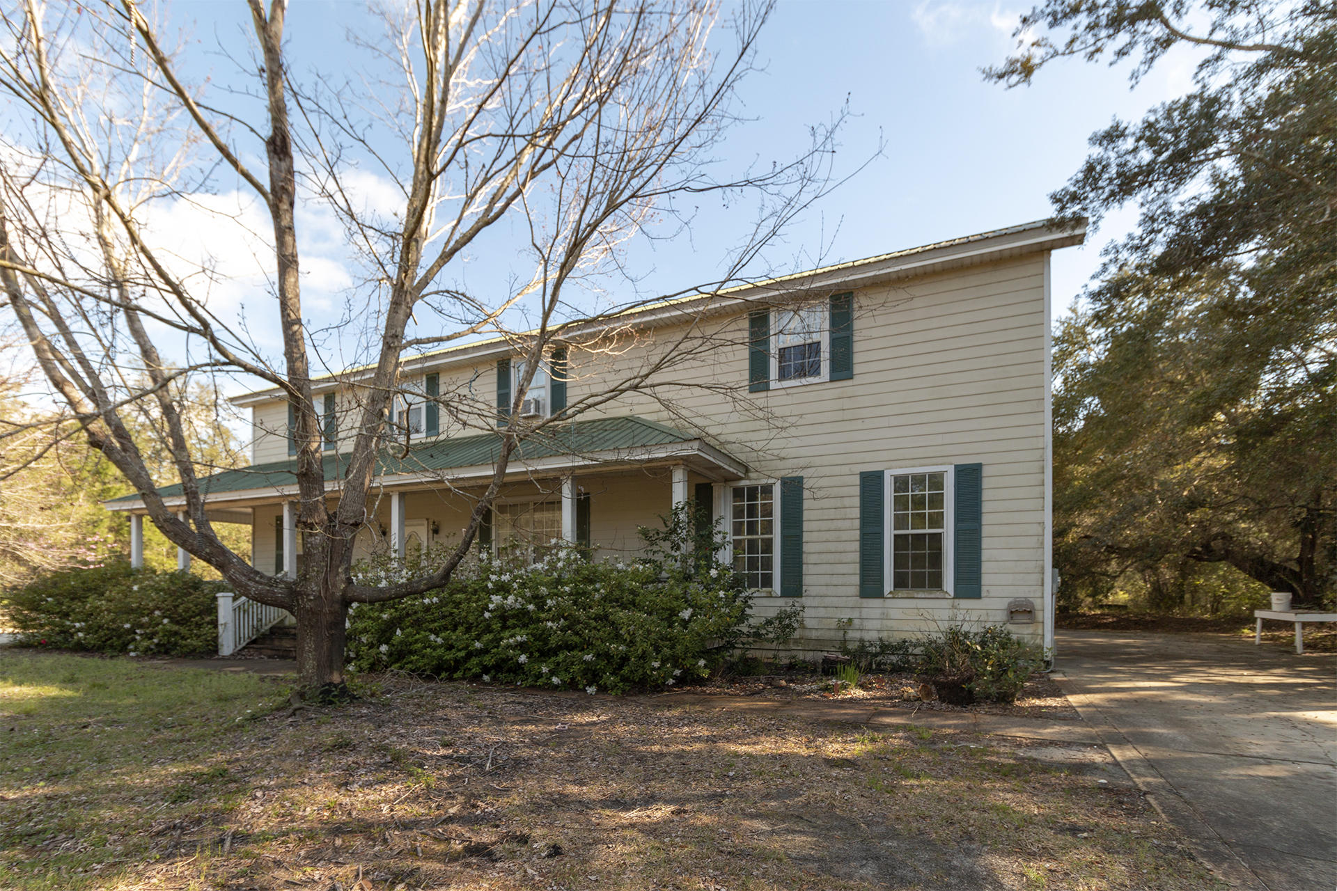 Don't miss this great opportunity to own this 3BR/2.5BA Home with 1BR/1BA Apartment. This home is being sold AS-IS & has amazing potential. Located on a half-acre, this home includes a private pool, yard building, & large wrap-around porch. The first floor has a large living space, dining area, laundry room, half bath, & kitchen. The kitchen features wood cabinetry, white appliances, center island, & plenty of countertop space. Upstairs you will find two nice sized bedrooms and a full hallway bath. Also, upstairs is the large master suite with walk-in closet, double vanity, & sitting area. Above the oversized two car garage is a 1BR/1BA apartment with full kitchen, bedroom, & bathroom with washer/dryer. Other features include metal roof, hardboard siding, & just a short walk to the bay.