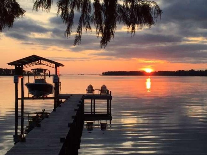 Truly a Rare Find! Very well maintained, Waterfront move-in ready home in a great neighborhood! The sunsets are priceless!! Full deep-water access from your own deck/dock with electric boat lift! Transition into your home, hosting an open floor plan, great for entertaining! Extra-large pantry and Laundry Room with storage galore! In the evening, you'll be thrilled relaxing in your oversized Master Suite - 19 x 17, two walk-in closets and an oversized walk-in shower. Wake-up to the most glorious views and start another amazing day!