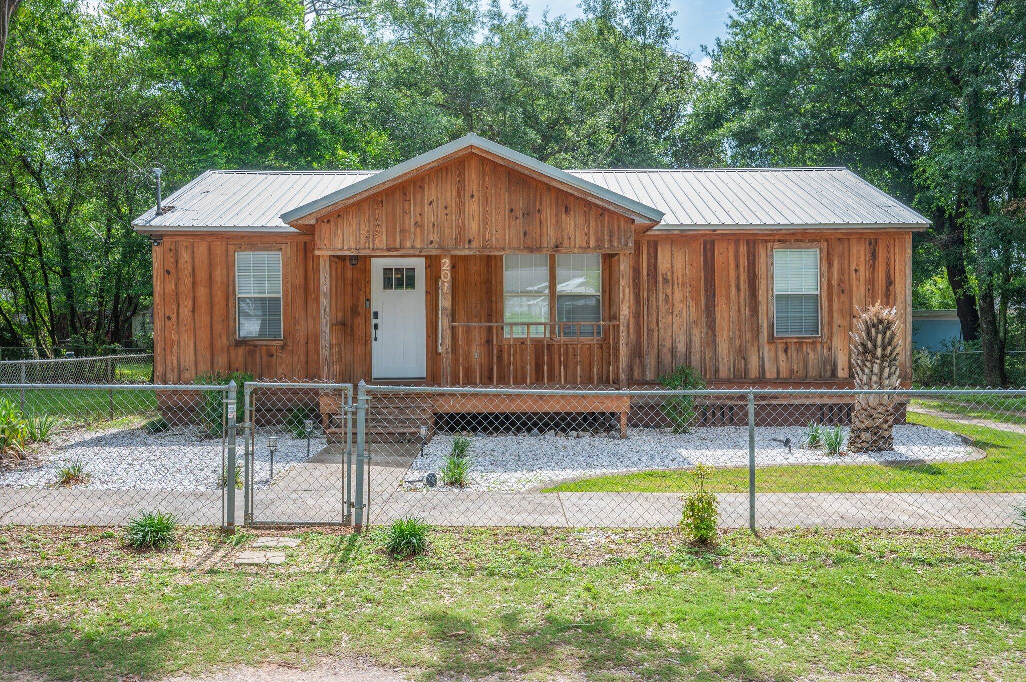 WELCOME to this completely refreshed two bedroom, 1.5 bath cottage! This cozy home has been completely remodeled since 2021. The effective age of the house has been updated to 2020 on the property appraiser site. New plumbing, wiring, siding, metal roof, HVAC, sheetrock, ceiling treatments, lighting, countertops, bathroom, LVP flooring, deck, landscaping... you name it... no detail overlooked! Make an appointment to see this beauty today!