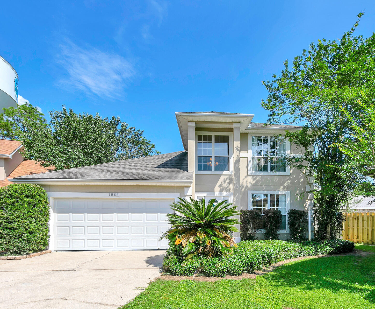 Gorgeous 3 bedroom and 2.5 bath home with 1762 sq ft and an enclosed Gunite pool and Lanai located in the desirable North Ridge Creek Subdivision! This home is minutes to the air force bases, beaches, great schools and restaurants! There is a newer 30 year dimensional shingled roof (2019) and a newer downstairs Heating and Cooling Unit (Rheem). Enter the two story stucco home and notice the double height ceilings with a large chandelier in the foyer! The home has an open floor plan with a large living room space opening to the dining room area, and kitchen area.