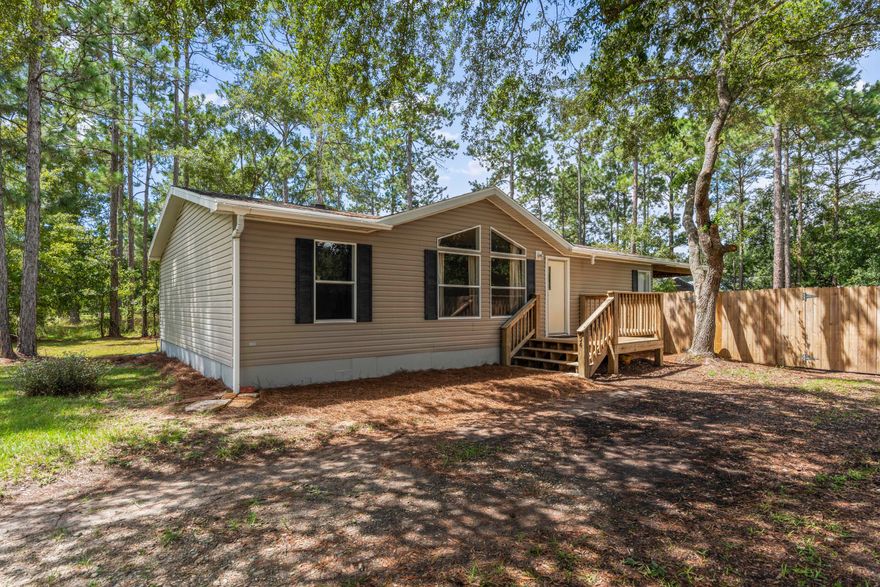 This well maintained 3 bedroom 2 bath home includes all of the appliances along with the back porch swing. It sits on a large half acre lot shaded by mature oak trees. The living room has a cathedral ceiling that highlights the large windows that give the room an abundance of natural light. Located less than a mile from the Black Creek Lodge boat ramp with plenty of room to store your boat in the large fenced in back yard. Keep your fishing gear and yard tools in the freshly painted shed. This property sits in a very well manicured neighborhood with no HOA.