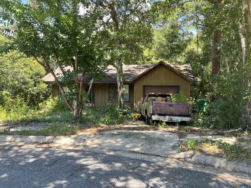 Home is possibly salvageable. Charming neighborhood with quick access to schools, shopping and 293 ByPass.  Property is located on a cul-de-sac and backs up to wooded conservation area.