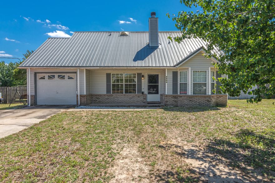 South of I-10!!! Three bedroom, two bath home with one car garage. Living room features a wood burning fireplace. Eat in kitchen with tile floors opens to a sunroom. Downstairs are two bedrooms with a jack and jill style bathroom. Upstairs is master bedroom & bath. Flat lot with fenced back yard.