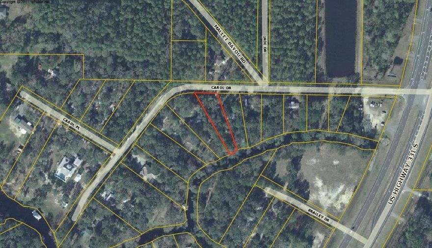 RARE FIND IN TODAY'S MARKET! Canalfront lot that allows manufactured homes. Wooded lot just off Highway 331 South, on a paved road and south of Highway 20. Almost too good to be true. Great spot for a weekend get-a-way or build a new home for permanent living. City water is available. Canal leads to Mallet Bayou and then to Bay. Small boats are best in the limited waters of the canal. Freeport is growing and there are only so many waterfront lots. Don't wait too long to buy waterfront . . . or it will be gone.