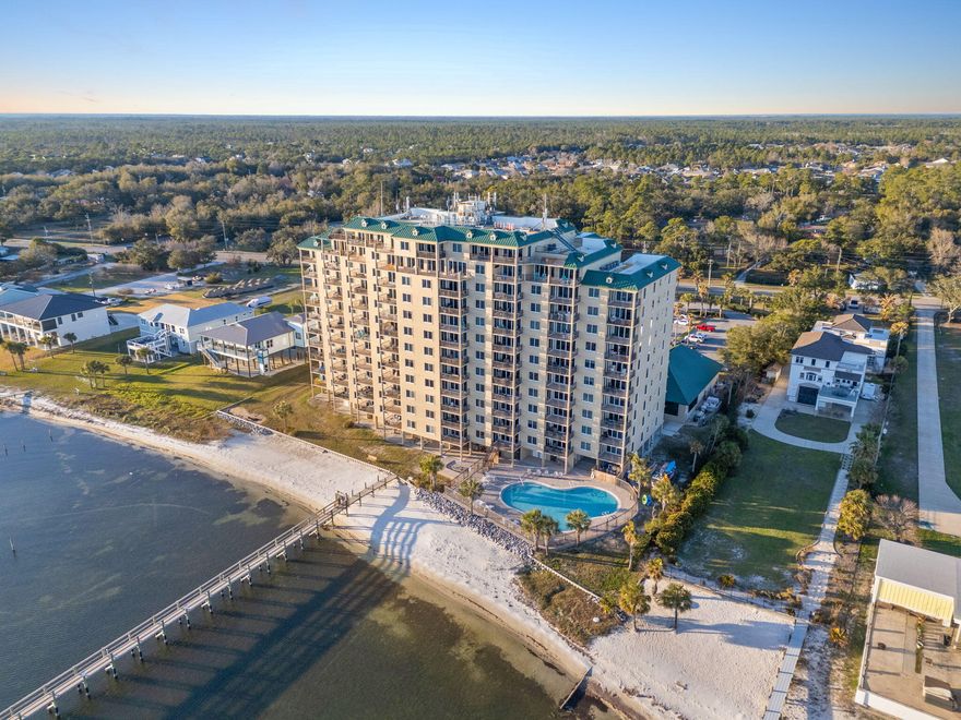Experience the perfect blend of comfort, style & coastal charm in this beautifully upgraded 3-bedroom, 3+-bath CORNER unit at Snug Harbour Condominium with glorious sunrise views! Nestled along the Intracoastal Waterway, this waterfront residence offers breathtaking views of the Gulf Islands National Seashore & Perdido Key. The thoughtfully designed kitchen features sleek, hidden outlets under the cabinets, a convenient lazy Susan in the corner, & added storage under the bar on the living room side. Stainless steel appliances & elegant countertops grace both the kitchen & baths, adding a modern touch. Enjoy the custom touches throughout -- from the added cabinetry in the laundry room to the master closet designed for ultimate organization. The living room boasts a stylish custom coffee bar furniture piece & electric shades for effortless ambiance control. A newer washer & dryer offer added convenience, & the HVAC was updated in 2020. Enjoy the convenience of your own ground-floor storage closet & the exceptional amenities that Snug Harbour has to offer! Boating enthusiasts will love the private dock, with slips available for separate purchase, providing the BEST location just minutes from the Pass. Relax & unwind with two pools  one overlooking the stunning Intracoastal Waterway & another indoor pool  plus an indoor spa, sauna, state-of-the-art fitness center & a welcoming community room. Whether you're looking for a primary residence, a second home, or an investment property, Snug Harbour is the perfect choice! Please note: rentals are restricted to a 30-night minimum. Don't miss your chance to own a slice of coastal paradise  schedule your showing today!