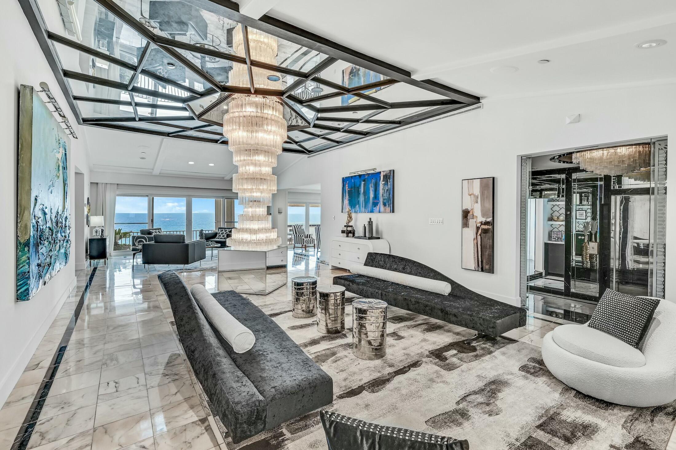 Calling all maximalist lovers, this is the condo for you! This glitzy penthouse with over 4000 sf has old Hollywood glamor, with a modern touch, that is nothing short of spectacular. Views reign supreme in this beachfront palace in the sky, which has gulf views from 6 of its rooms. In addition, this 3 bedroom condo has a bonus room that could easily become a 4th bedroom on the gulf side. Some original features include shimmering hand-blown glass chandeliers, Italian etched mirrors, 3D wallpaper, bar room with wine storage, and marble floors throughout. A recent addition is a chef's kitchen with quartz counter tops, new Dacor/Bosch appliances, and butler's pantry. This condo is perfect for anyone who entertains with large rooms flowing from one to the other, and a spacious balcony.