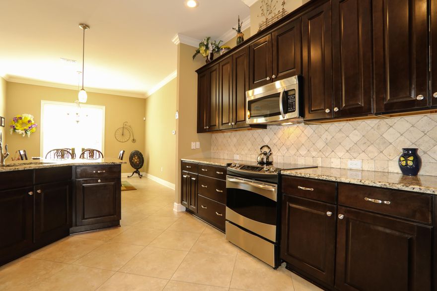 Distinctive Property. This magnificent residence is what dreams are made of! This home was built by the locally owned Randy Wise Homes homebuilder, which has been renowned for both the quality and design of their homes. The moment you pull up to this home, this brick beauty will draw you in with its distinct design, lush landscaping, and friendly front porch. Upon entering the home, you will notice the sprawling open floor plan, 10' ceilings accented with crown molding, and 20 porcelain tile throughout the common areas. Because of the carefully designed floor plan, the foyer, living room, and dining area flow into one another beautifully. The kitchen brims with modern appeal and warm livability. With upgraded cherry cabinetry, granite countertops, porcelain tile, a breakfast bar, stainless steel appliances, and a large walk-in pantry, you will cook in style and with ease! Entrance to the large open deck is available from the dining area and would be a great place for grilling. After a long day, escape to your luxurious retreat in the master bedroom and bathroom. The master bedroom is spacious, so there is plenty of room to add a king-sized bed and bedside tables. Store all of your clothes, shoes, and any other belongings in the large walk-in closet. In the ensuite you will find an inviting garden tub, tiled walk-in shower, and a double vanity. Guests will enjoy the privacy offered by the split bedroom floorplan, as well as the Jack & Jill bathroom. This floor includes three bedrooms, one half bathroom, and two full bathrooms, with potential to add another bedroom/bathroom on the basement level!
From the first floor, walk downstairs into the finished basement that includes bamboo flooring throughout. So many incredible features can be found on this level. There is a beautiful wet bar complete with granite countertops, as well as a parlor area that can fit a large table. There is also a workshop, den area, sitting room, 1 bedroom and 1 full bathroom. Just off the bedroom is a concrete-reinforced storm shelter. The basement also features a walk-out covered patio so both you and your guests can head outside with ease. Home is located near A-rated schools, shopping, and is just 15 minutes from Eglin Air Force Base. Make your dream a reality and call today to view this home!