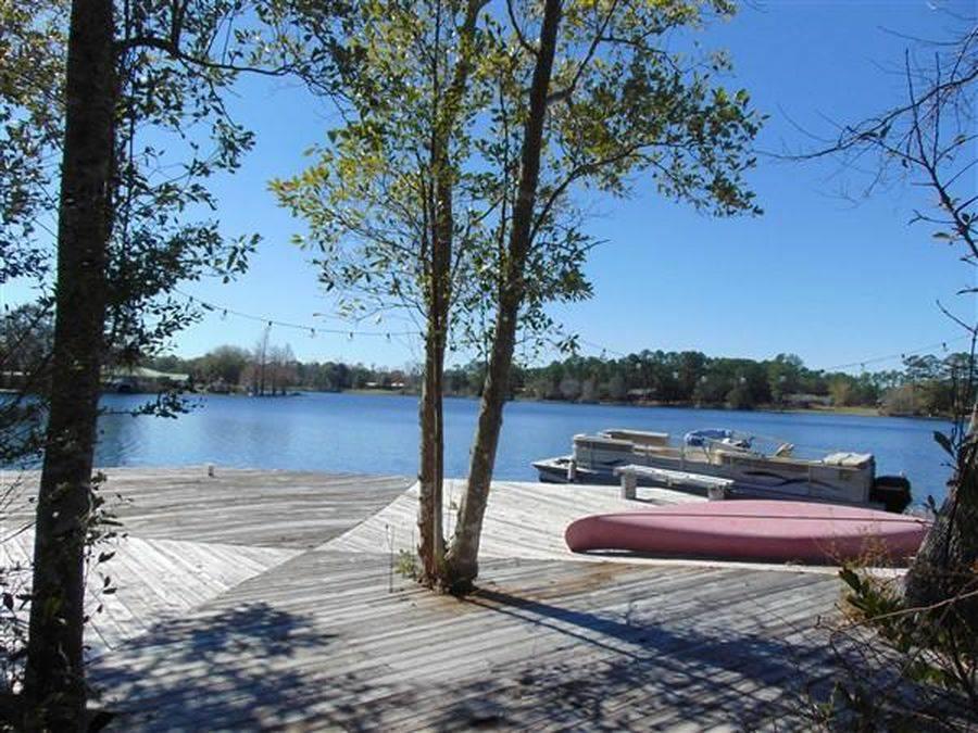 Beautiful waterfront home, just off of 331 in Defuniak Springs. It boasts 4 bedrooms 4.5 bathrooms plus an office space. Always be refreshed with the 35'x19' swimming poo on the huge brick deckl. This home is located on a 4 acre secluded lot. 3300 sq ft. Each bedroom has it's own entrance to the brick patio which spans the whole back of the home.