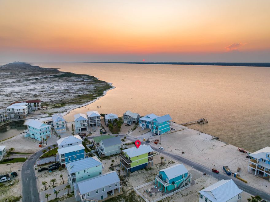 Thoughtfully designed 5-bedroom, 3.5-bathroom beach retreat overlooking the Santa Rosa Sound! Located within the growing Grand Navarre community and just down the street from public beach access, this home combines breathtaking sound views, indoor/outdoor living, and modern comforts with over 1,200 sq. ft. of balcony space and balcony access from EVERY bedroom!&#8232; Maximizing scenic sound views, the reverse floor plan lands the heart of the home on the top floor. Soaring 14-foot vaulted ceilings create an airy ambiance, seamlessly connecting the open-concept Chef's Kitchen, living, and dining areas to a spacious sound-facing balcony complete with an outdoor kitchen. This level also features a convenient powder room and two generously sized bedrooms. The second floor boasts 10-foot ceilings and includes two additional bedrooms and an oversized Primary Suite. The Primary Suite is a private sanctuary, featuring a massive private balcony, a walk-in closet, and a spa-inspired en-suite bath with a pebble-stone double rain shower, dual vanity, and in-suite washer/dryer.
The newly painted garage doubles as a recreation hub, offering seating, games, and a TV perfect for relaxing after a day at the beach or staying entertained on rainy days. The french door exit leads directly to the backyard firepit for cozy evenings and s'mores!
Located in the vibrant Grand Navarre community, this home provides easy access to walking and biking paths, local shopping, dining, and the stunning Gulf Islands National Seashore. With its proximity to public beach access and tranquil surroundings, this property is ideal for both owners and guests seeking the ultimate coastal lifestyle.
