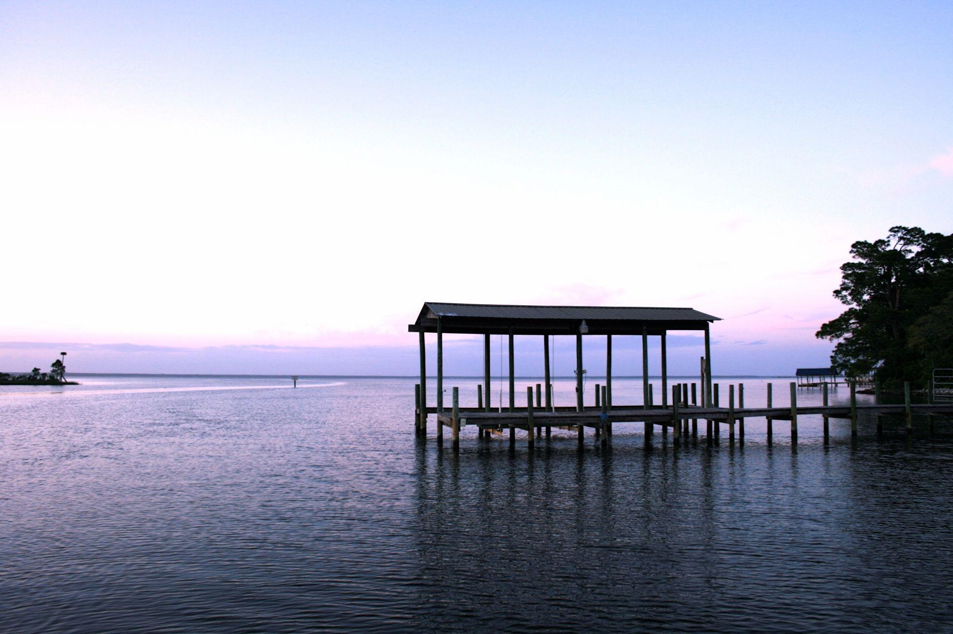 Nestled at the opening of Hewett Bayou, this estate size lot offers the serenity and privacy that discerning buyers desire. The expansive waterfront peninsula (372' per survey) offers views of the Choctawhatchee Bay, Hogtown Bayou and Hewett Bayou. Covered dock and electric boat lift in place. Previously 2 separate lots that were combined, the possibilities are endless. Keep your privacy or potentially subdivide back into 2 lots with county approval, perfect for builders looking for 2 waterfront lots or potential family compound. For the nature lovers, enjoy the playful dolphin and osprey that frequent the property. For the anglers, enjoy a dynamite year round fishery for redfish and trout. Water and electric in place at the dock. Dead end street! Potential Owner Financing Available!