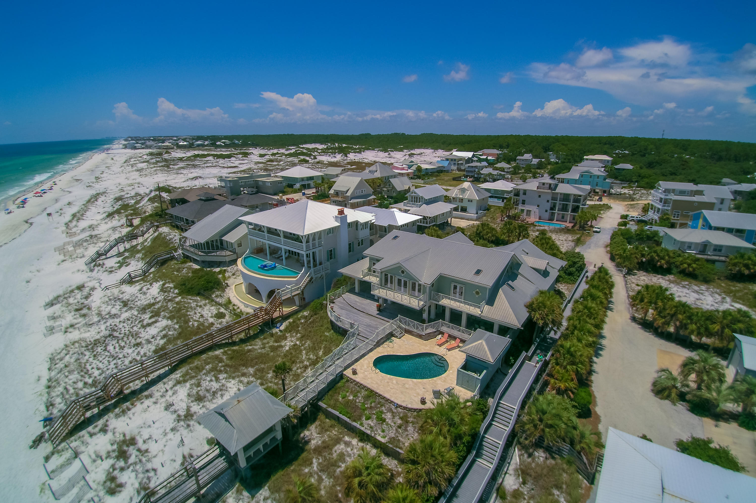 Exceptional value, PRICED TO SELL! Newlyremodeled with luxurious new interiors and finishes, 59 Auburn Drive is now priced to sell! This expansive Gulf-front Grayton Beach residence is a rare and notable property. Spanning an impressive 100 feet on the Gulf and over 425 feet in lot depth, this home is projected to generate +$300,000 annual rental revenue, with established 2017 bookings +$278,000. Fully renovated in 2016, the large residence offers a desirable large and open plan, adjacent to a fully appointed carriage house above of most spacious garage. A carefully curated selection of designer furnishings, white pecky cypress paneling, and marble top counters and vanities throughout, present a style of opulent coastal elegance. Two master bedrooms found in the main house, one on each