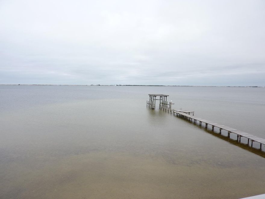 THIS JUST COULD BE YOUR DREAM HOME. HOME NEEDS SOME UPGRADES BUT ARE COSMETIC IN NATURE. YOU WILL BE GETTING A MILLION DOLLAR VIEW FOR MUCH LESS. WAKE UP TO BEAUTIFUL SUNRISES AND ENJOY FANTASTIC SUNSETS ON EITHR OF TWO HUGE BALCONIES. HOME FEATURES A DOCK WITH JET SKI PODS. IT ALSO FEATURES A MOST UNUSUAL SEA WALL.