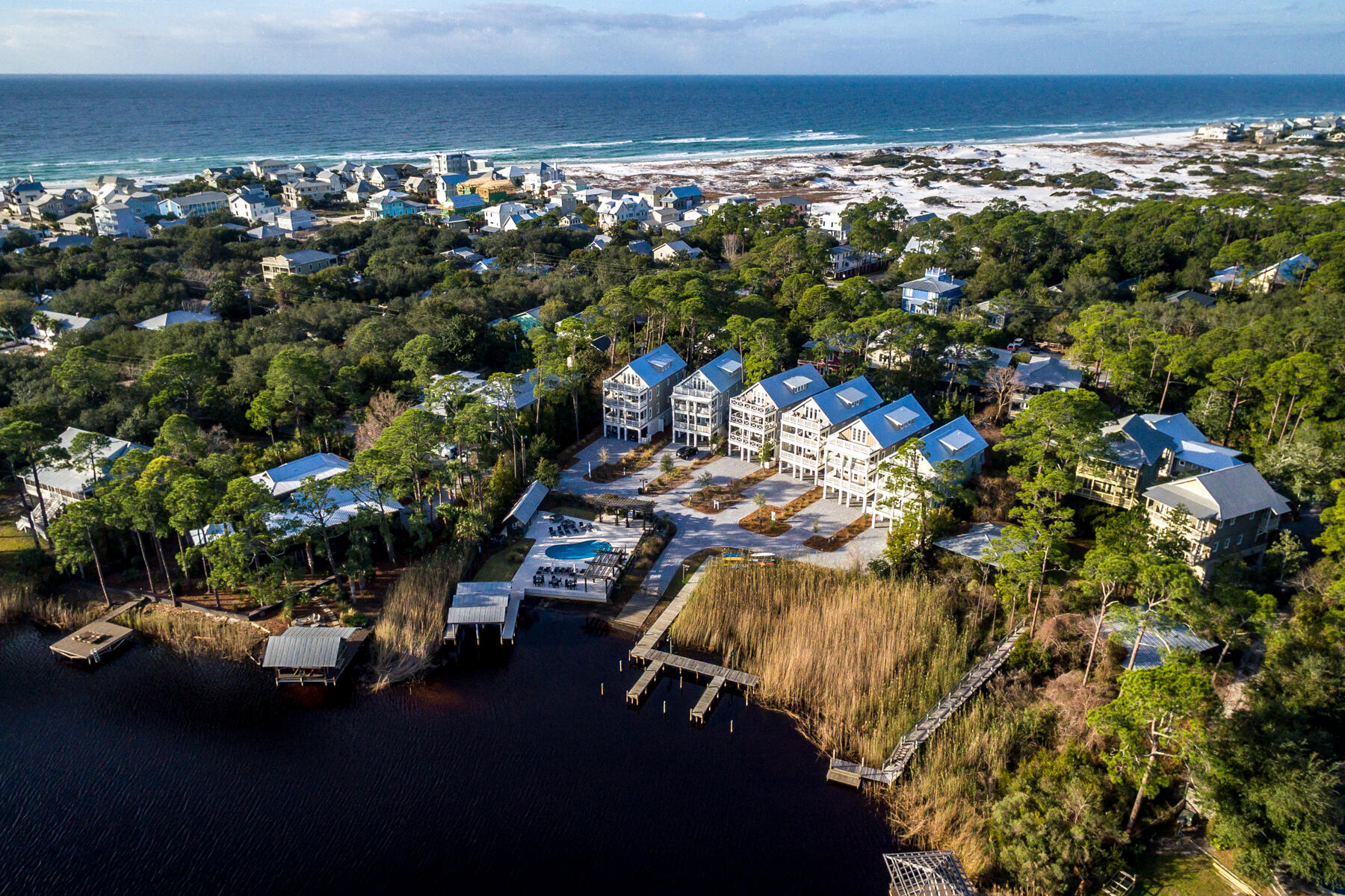 Under contract with a Back-up contract in place. Experience the finest in coastal living with this five-bed, five-and-a-half-bath custom home overlooking  Western Lake in Grayton Beach. Fully furnished for turnkey use or an investment opportunity, this Grayton Landing home is situated in the only gated community in Grayton Beach with a lakefront community pool and boat launch.. This home offers spectacular views of the lake from every floor and a covered boat slip conveys with the sale. Constructed by Southern Living recognized builder Luke and Blue's Custom Homes. Owners will enjoy almost 3,600 square feet of living space, an open-concept floor plan, 800 square feet of porches overlooking Western Lake and a large screened outdoor living area, with entertainment wet bar and fire pit.