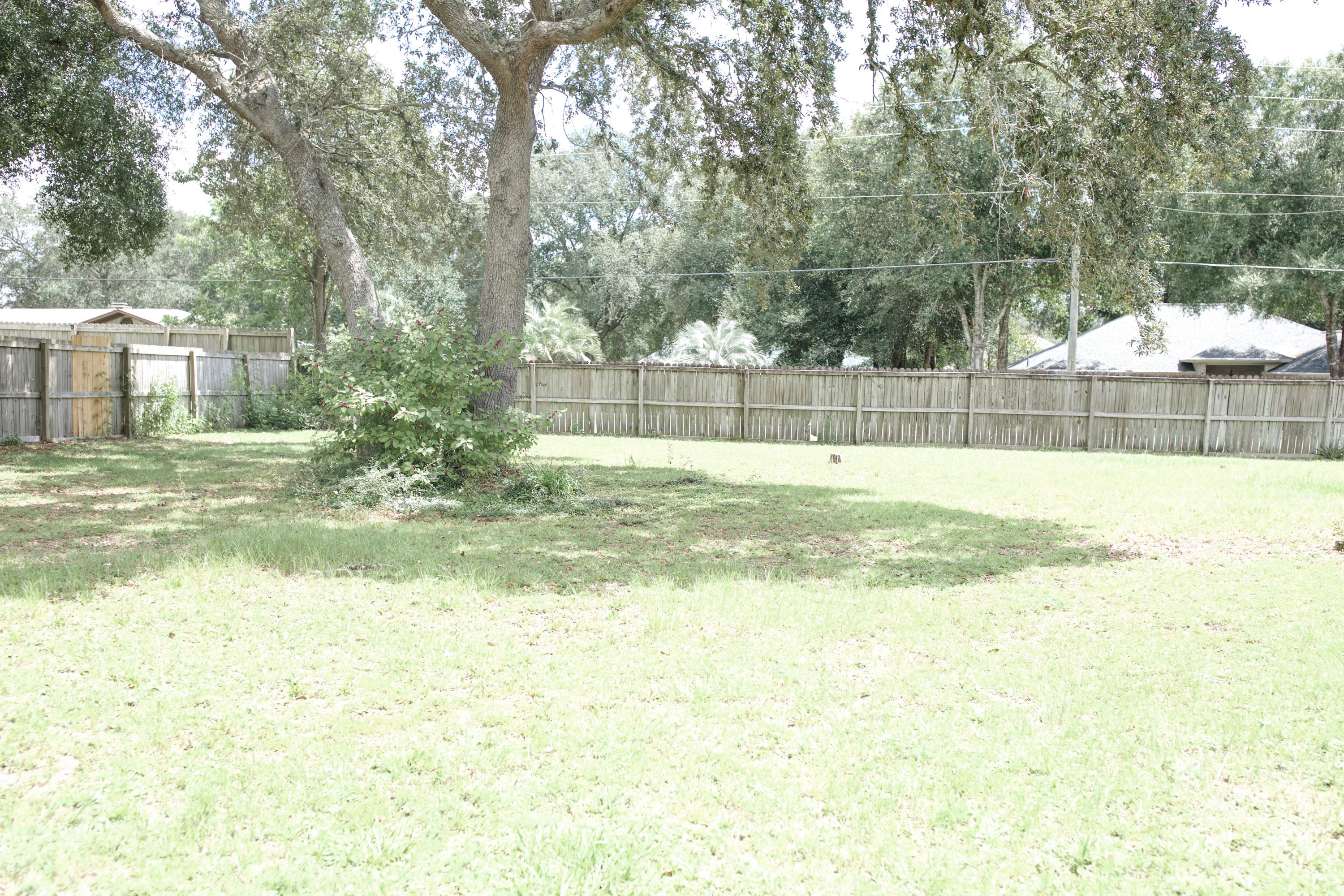 LOCATION, LOCATION, LOCATION. This well maintained 3 bedroom, 2 bath home has many nice conveniences.....a big lot, a fireplace, a two car garage and a workshop with electric. Patio features a brick outdoor fireplace. The kitchen is open and has lots of counter space and oversees the dining room and living room. You can enjoy the warmth and charm of the fireplace during the winter. There is a split bedroom design, with the master off of the dining room. Outside, there is plenty of room for a garden. This home is situated on a half acre lot in a quiet neighborhood and is just south of I-10. Convenient to Duke, 7th Group, Hurlburt and Eglin bases. The roof was replaced in 2006 and the septic system was replaced in 2006.