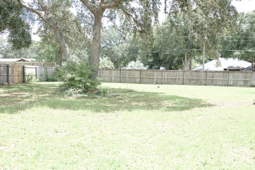 LOCATION, LOCATION, LOCATION. This well maintained 3 bedroom, 2 bath home has many nice conveniences.....a big lot, a fireplace, a two car garage and a workshop with electric. Patio features a brick outdoor fireplace. The kitchen is open and has lots of counter space and oversees the dining room and living room. You can enjoy the warmth and charm of the fireplace during the winter. There is a split bedroom design, with the master off of the dining room. Outside, there is plenty of room for a garden. This home is situated on a half acre lot in a quiet neighborhood and is just south of I-10. Convenient to Duke, 7th Group, Hurlburt and Eglin bases. The roof was replaced in 2006 and the septic system was replaced in 2006.