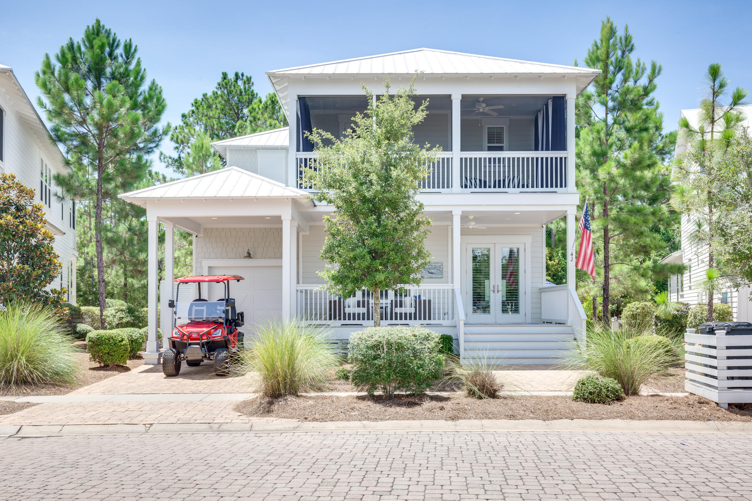 Welcome to the scenic semi-circle of NatureWalk at Seagrove! Salamander Circle is such apretty street with picturesque front and back yard views! Enjoy the lovely duck pond out frontand beautiful nature trails in the back. 42 Salamander is stunning and PRISTINE! As you walk upto the home you'll notice carport to shield your golf cart (that comes with the house) & hugedouble porches, perfect for enjoying peaceful afternoons. Upon walking inside you are greetedwith a cozy sitting room and the main hallway leading into the open concept kitchen and livingarea. Stunning upgrades drip from every aspect of this home. From marble countertops &cabinets all the way to the ceiling to white beams & a fireplace. The spacious 1st-floor ownersuite lays just behind the living room