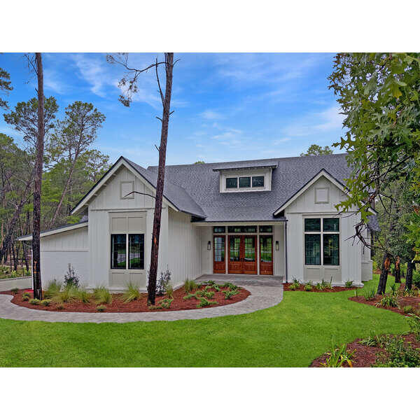 This stunning NEW CONSTRUCTION home Wild Heron is a single level home where modern craftsman design meets resort-style living. Welcome to a home where timeless design and modern luxury meet coastal serenity--just minutes from 30A and nestled within the gates of Wild Heron, one of Panama City Beach's most desired, fast growing communities on the shores of Lake Powell. Thoughtfully designed and construction just completed, this highly desirable, single-level masterpiece spans 3,300 square feet under roof and offers 2,401 square feet of interior living and over situated on a generous .37-acre homesite that backs up to conservation area offering both privacy and peaceful views. From the moment you step through the 8' solid Mahogany French doors, you're greeted by a sense of understated luxury. As you enter, you're greeted by a showstopping 24' cathedral vaulted ceiling in the living room, 12' ceilings flowing throughout, and an open concept anchored by a natural gas fireplace. Arched doorways add architectural charm and warmth, while modern, black Andersen windows and French doors to the patio flood the space with natural light. Step outside the living area to your private oasis where you'll find your own private, saltwater pool surrounded by a pavered deck, lush landscaping, and a vaulted, covered back porch plumbed for an outdoor kitchen.
The open-concept layout is both inviting and functional, perfect for effortless entertaining and everyday living. Enjoy white oak flooring throughout, along with a curated palette of classic tile selections in the bathrooms, mudroom, and a standout black-and-white checkered tile mud room and butlers pantry.
The kitchen is timeless and classic featuring white shaker custom cabinetry on the perimeter with a warm white oak wood island, Quartz countertops, and a full suite of Bosch appliances, seamlessly blending style and utility. A spacious butler's pantry off the mudroom and kitchen adds even more prep space with built-in shelving, generous counters, and a beverage fridge.
The primary suite is a true retreat with stunning conservation area views, shiplap clad vaulted ceilings, a spa-like primary bath with a soaking tub, zero-entry tiled shower, and a custom walk-in closet with double vanities paired with modern tile selections. With four bedrooms and three baths, this home offers a split floor plan that prioritizes privacy and comfort. All bedrooms offer walk-in closets, three bedrooms of the four bedrooms feature vaulted ceilings and a generous size Jack n' Jill bath with separate vanity areas allow for the best use of the third bathroom.
The 2-car garage offers tall ceilings for expanded storage and an EV-car charger for convenience of those with electric vehicles or golf carts. Crafted with enduring materials, brick and Hardie siding, this home captures the charm of classic craftsman style with the function and efficiency of modern construction with a coastal elegant twist.
Spanning 734 pristine acres along the shores of Lake Powell, Florida's largest coastal dune lake, this extraordinary community invites residents to slow down, breathe deeply, and savor the beauty that surrounds them. Morning strolls along miles of tree-lined walking trails, afternoons spent lounging at the resort-style lakefront pool, and evenings by the boathouse pavilion watching the sun set over the water, this is the rhythm of life here. With access to a community dock, fitness center, playground, and the opportunity to lease private boat slips with power lifts, Wild Heron was built for those who crave both adventure and serenity.
For those seeking the ultimate in exclusivity, Watersound Club membership elevates the experience with multiple private Club opportunities. In Wild Heron, enjoy the challenge of Shark's Tooth Golf Club, a Greg Norman-designed 18-hole masterpiece. Unwind at the clubhouse, sharpen your swing at the driving range, or hit the courts for a game of tennis.
