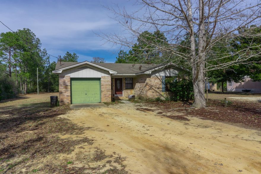 Welcome home to this spacious brick home located close to downtown DeFuniak Springs! The living room leads to the kitchen and dining area. The three bedrooms and bathroom are on the right side of the house and the garage is off of the kitchen.  The home has a private well and septic system. Sitting on 1 acre of land leaves plenty of room for a pool.  This would be a great primary home or rental property.  This home qualifies for USDA rural 100% financing. Located close to restaurants, shopping, entertainment, and about a 45-minute drive to the Gulf.   Call/text to set up your private showing today!